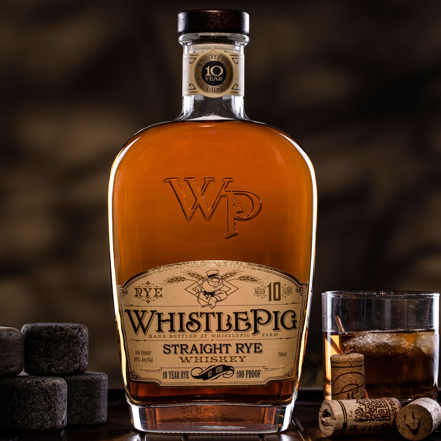 WhistlePig 10 Year Straight Rye Whiskey bottle with whiskey stones and cork beside it.
