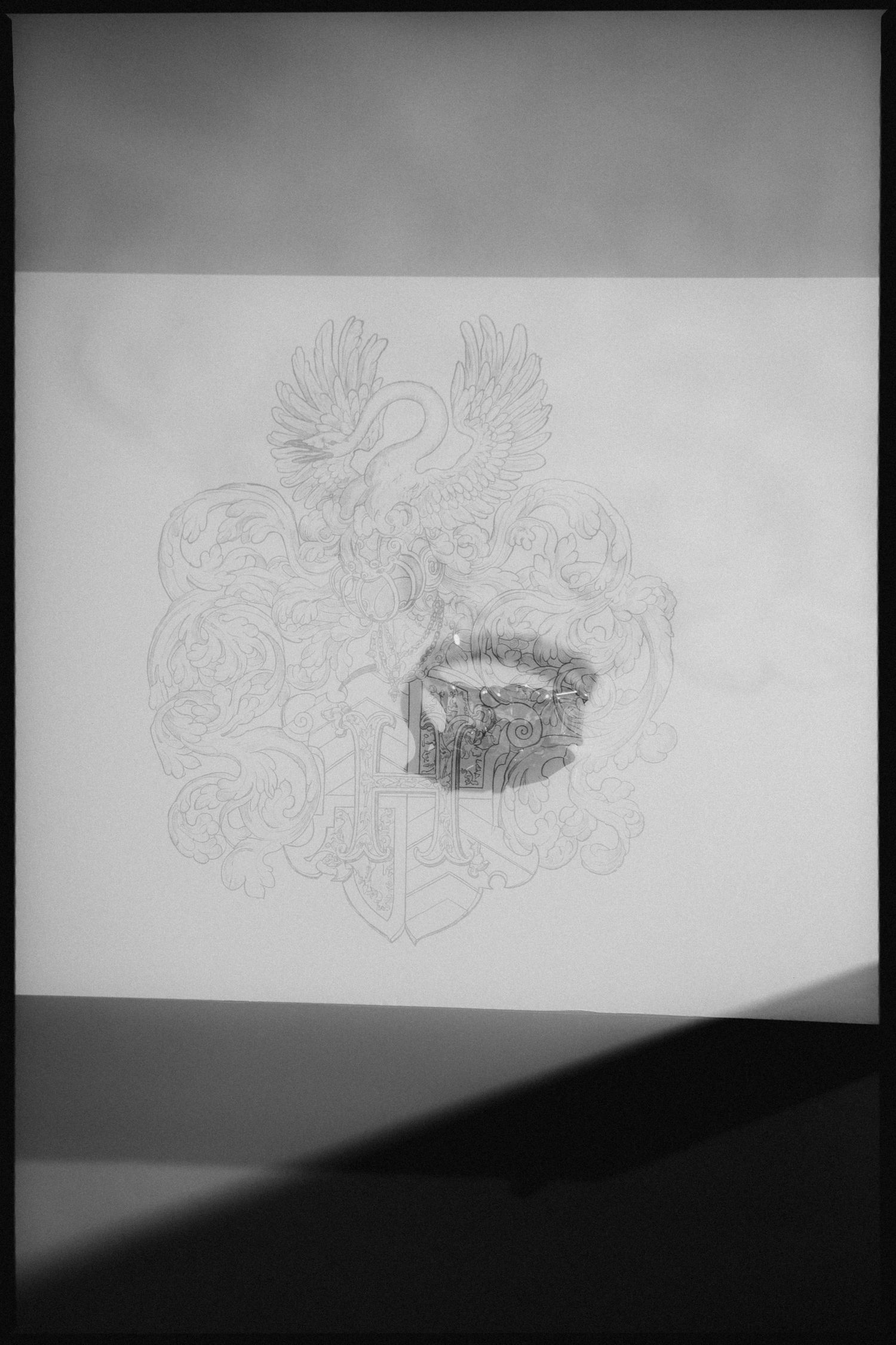Pencil sketch drawing of a heraldic coat of arms with eagle and ornate decorative elements on white paper.