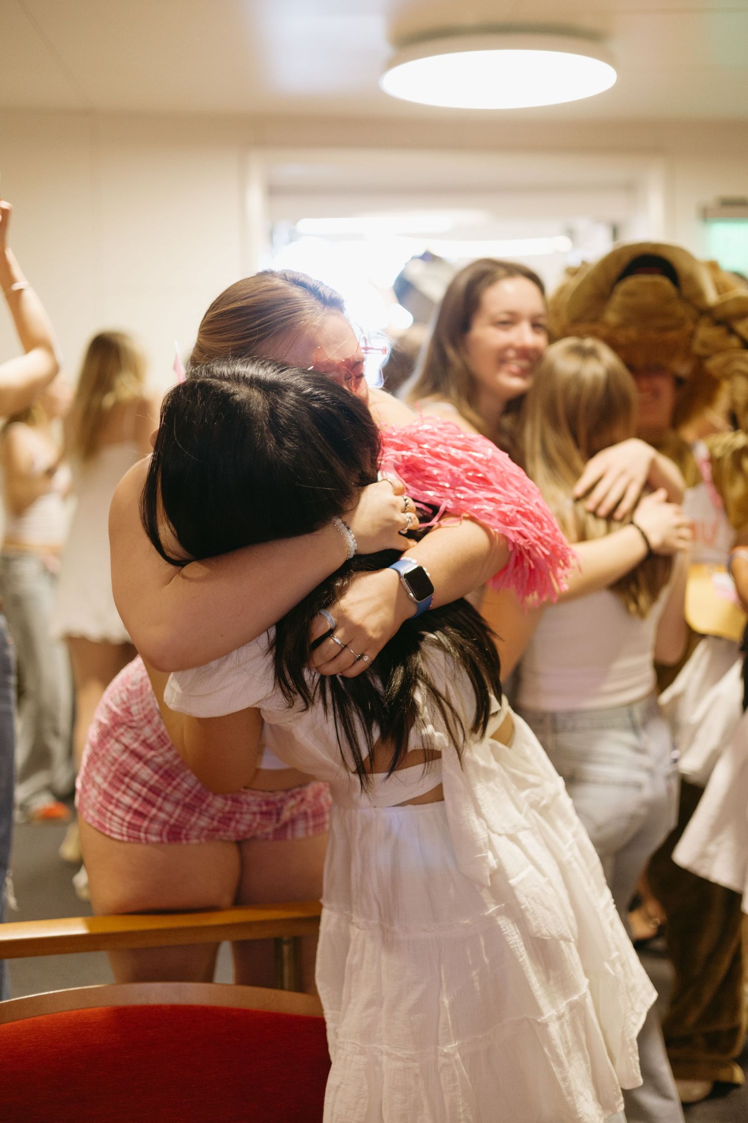 Group of wedding guests embracing and celebrating during a joyful reception party.