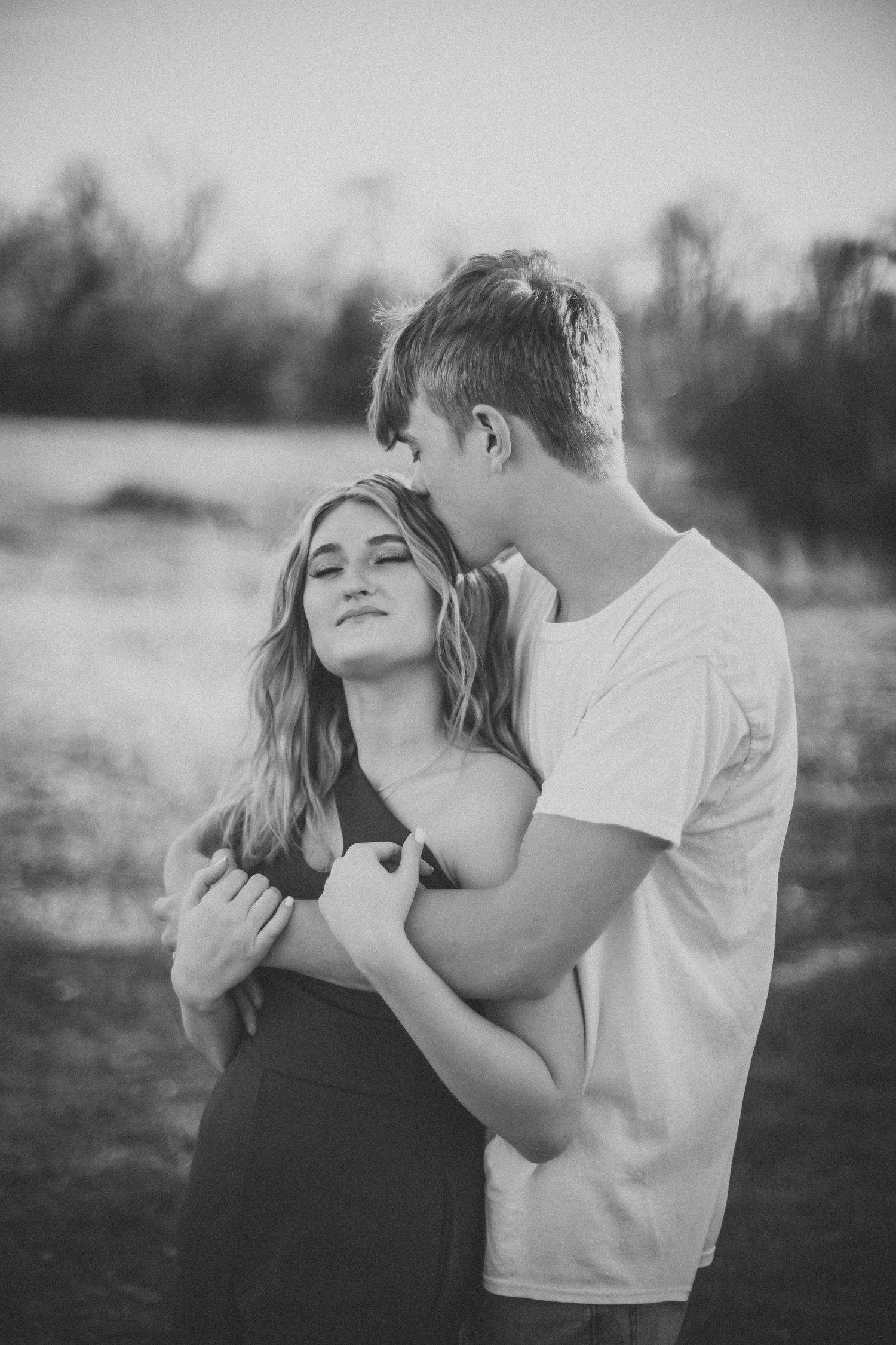 Black and white series capturing intimate moments between couple in outdoor setting.