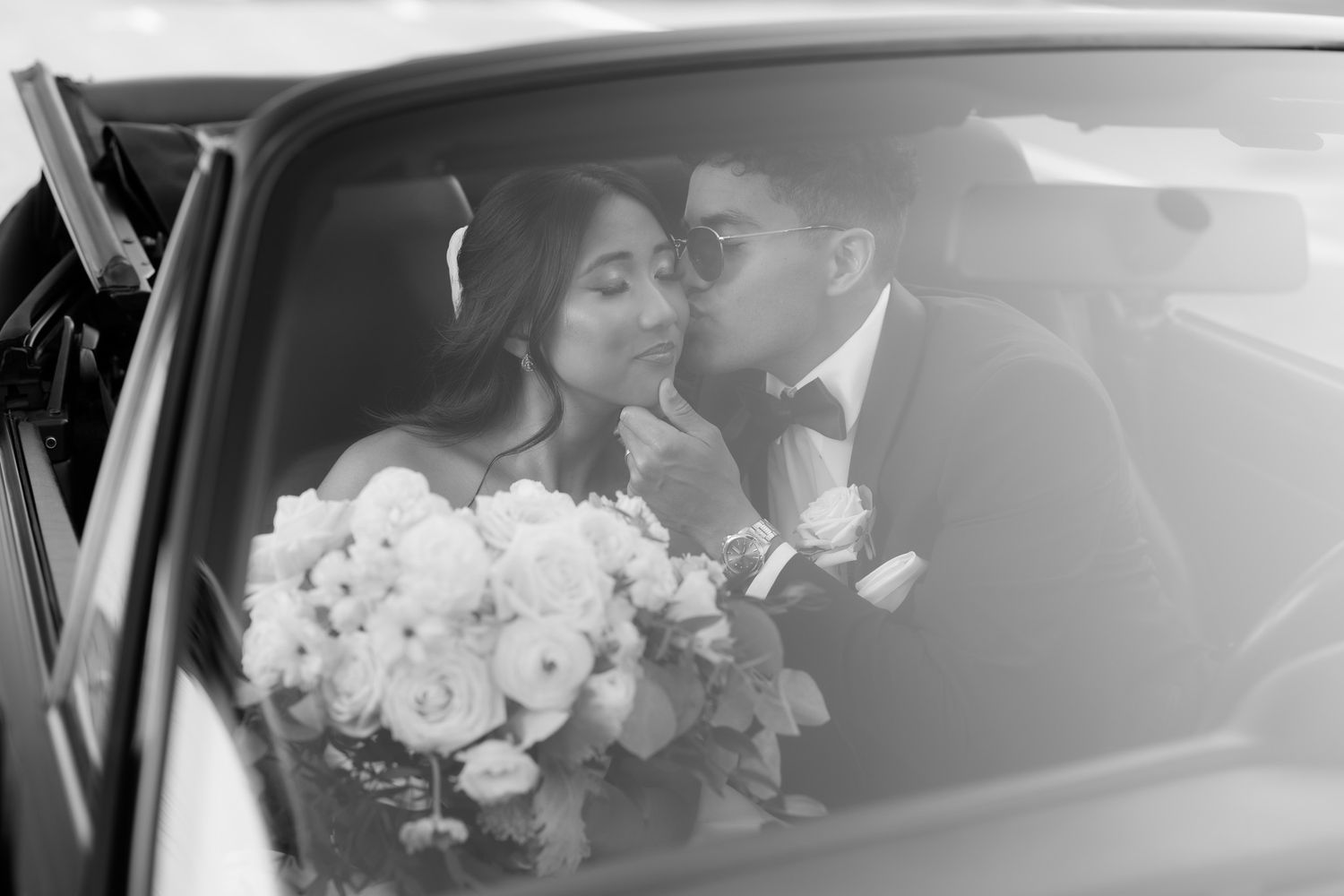 Elegant white roses arranged in a car bouquet with soft lighting and luxurious interior details.