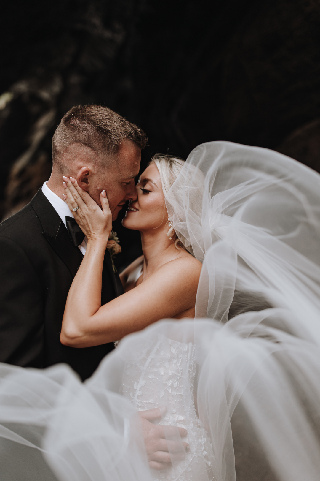 A romantic kiss between newlyweds at Watermouth Cove Weddings, Devon.