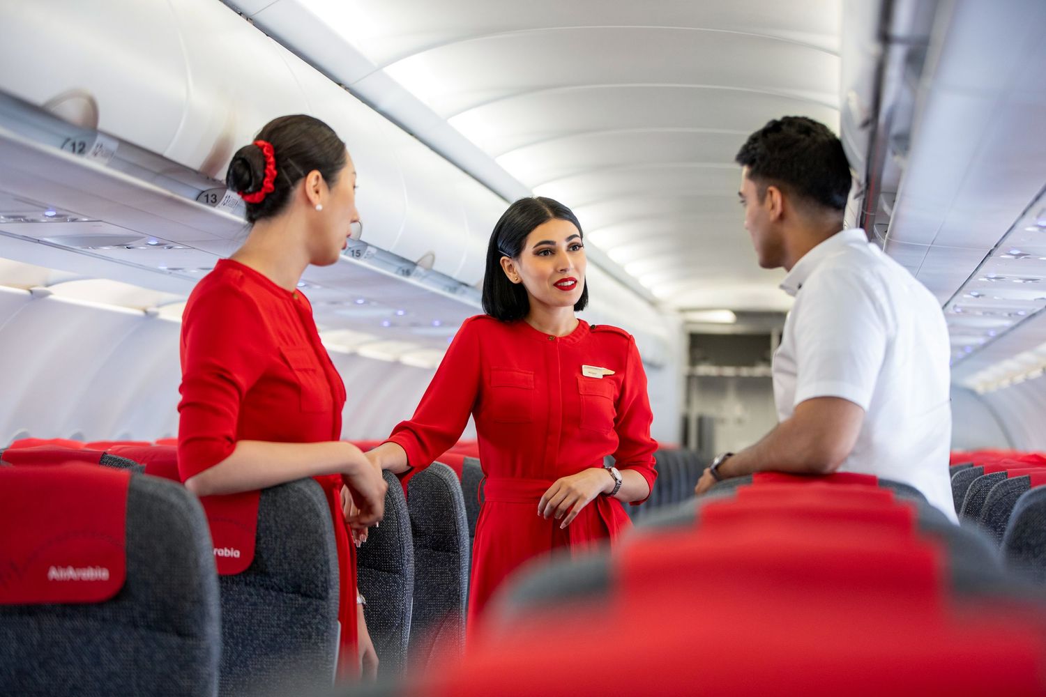 Flight attendants coordinating in cabin aisle – in-flight team communication photography and video
