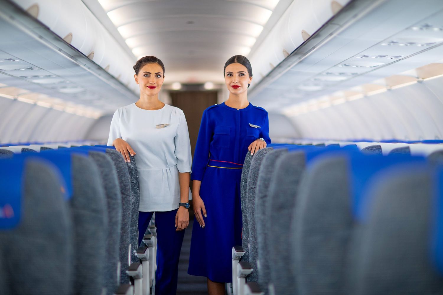 Flight attendants in the aircraft aisle created for photo and video content.