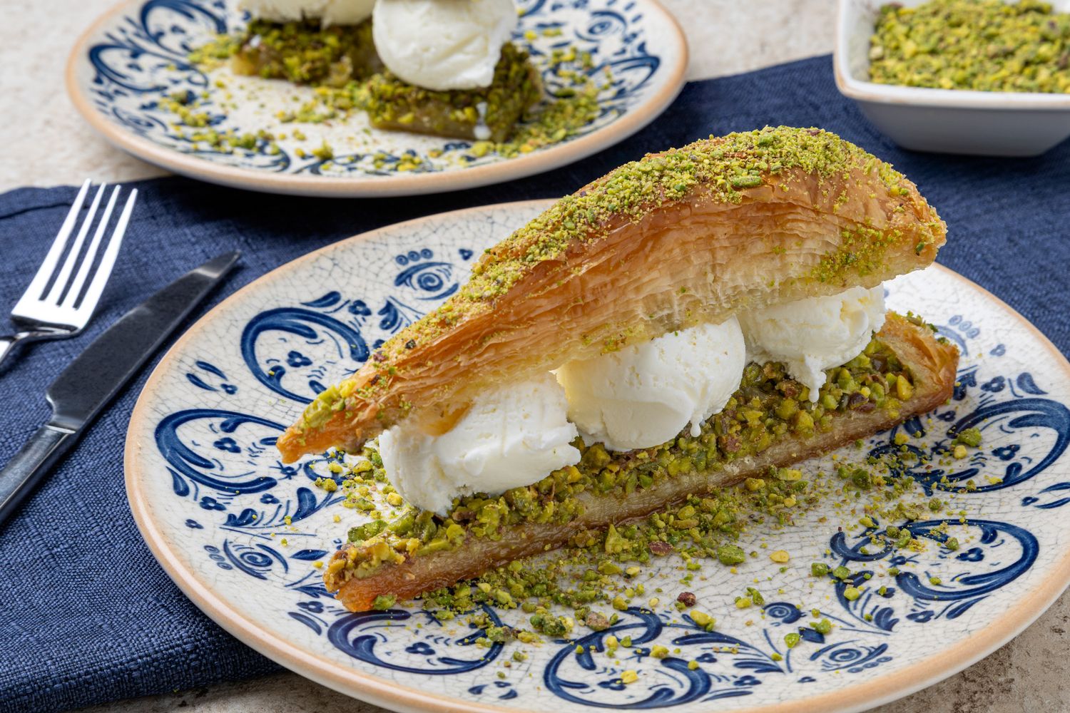 Professional Dessert photography of Turkish baklava dessert with pistachio and vanilla ice cream.