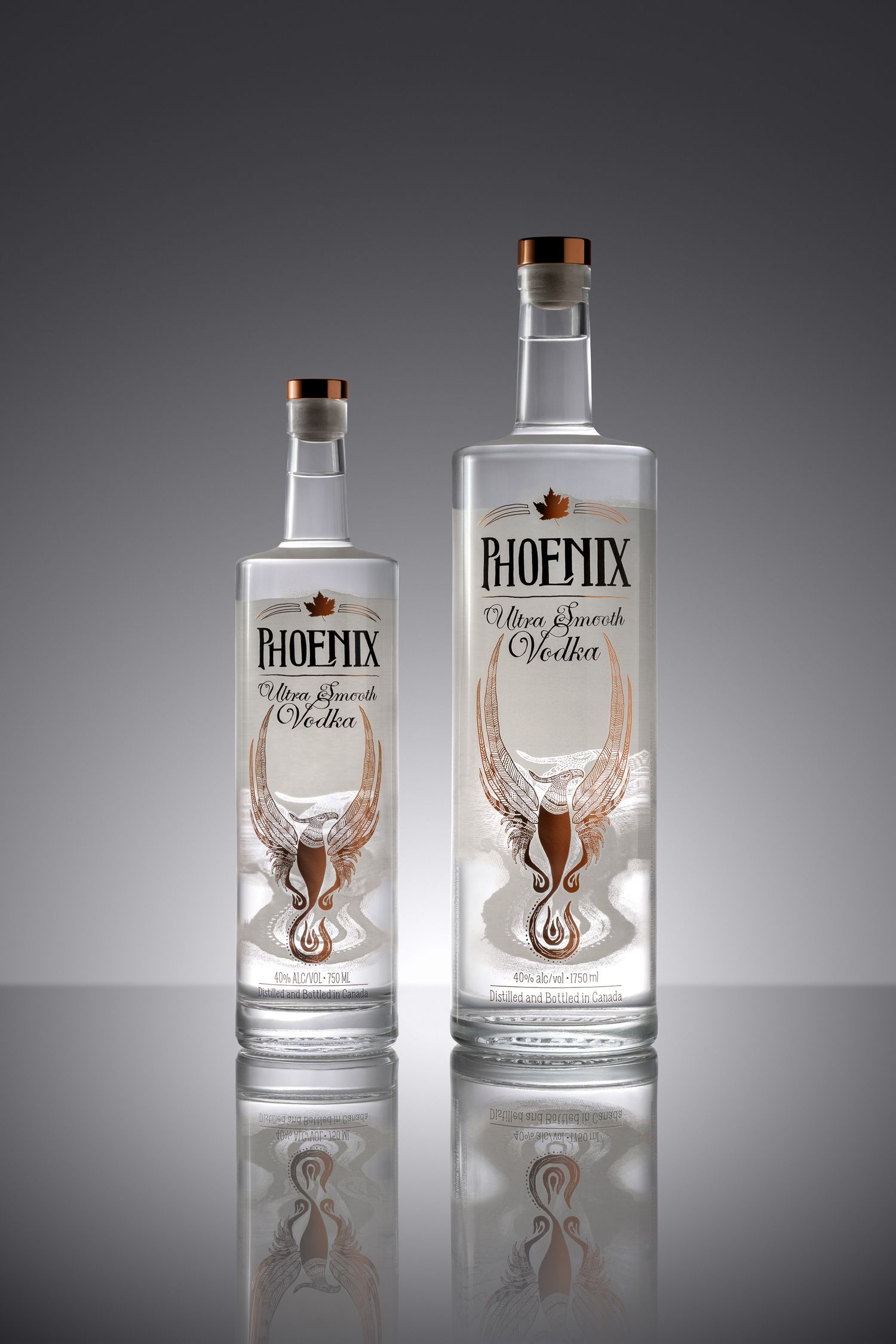 Two Phoenix Ultra Smooth Vodka bottles, one large and one small, displayed on a reflective surface against a gray background.