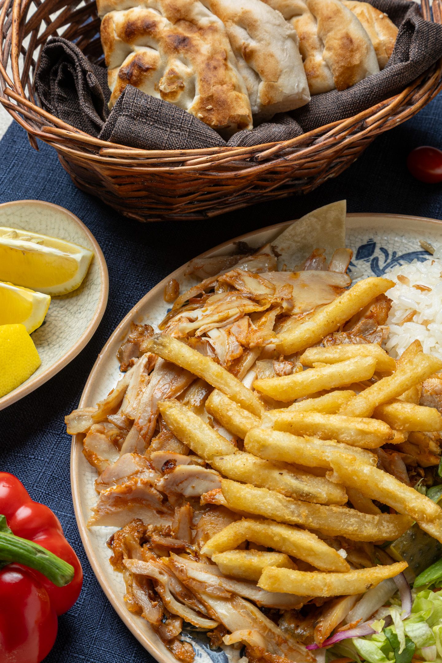 Food photography of a chicken doner platter served with French fries
