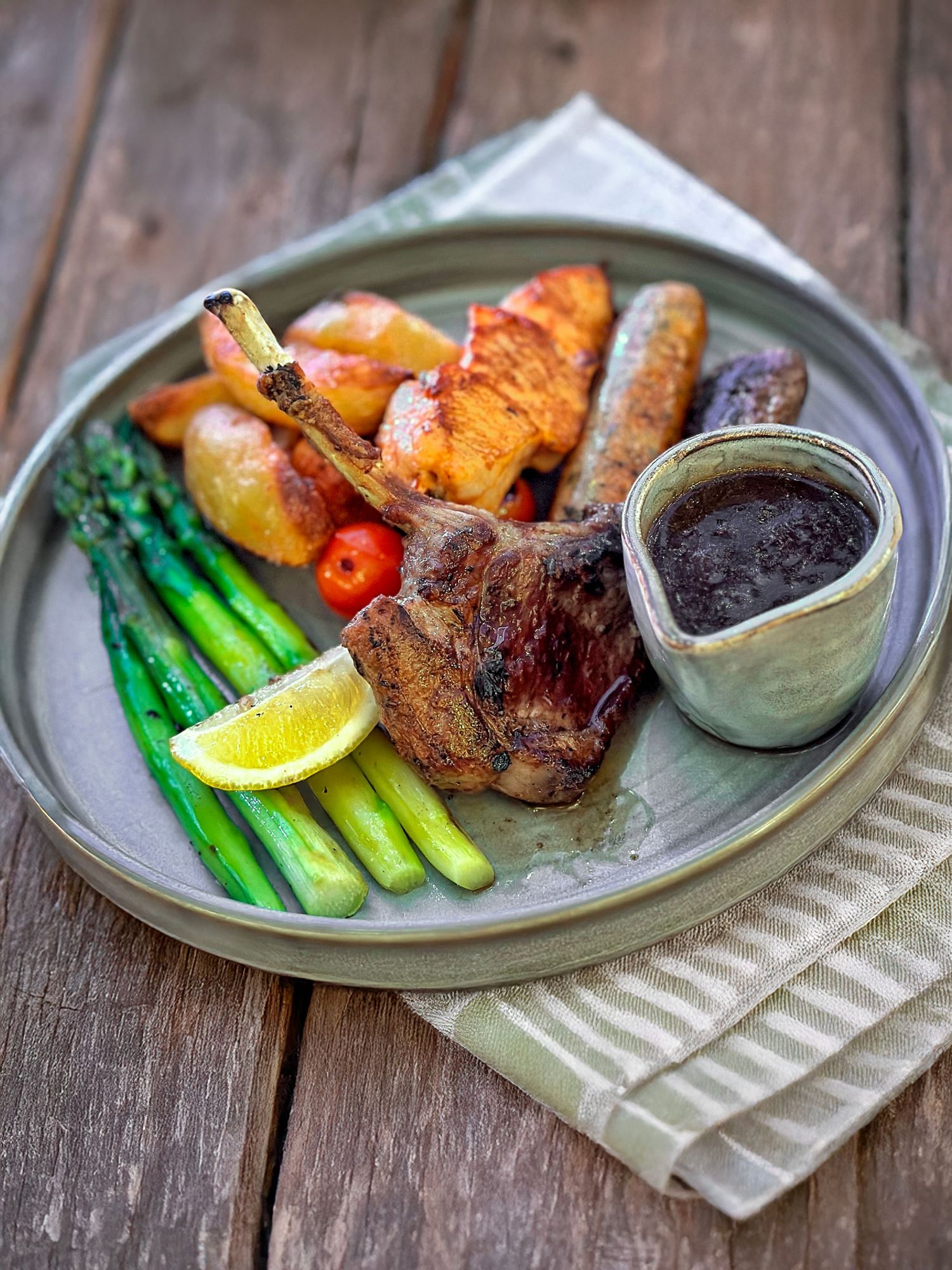 Fine dining food photography of grilled lamb chops with vegetables styled for commercial photography and short-form video content.