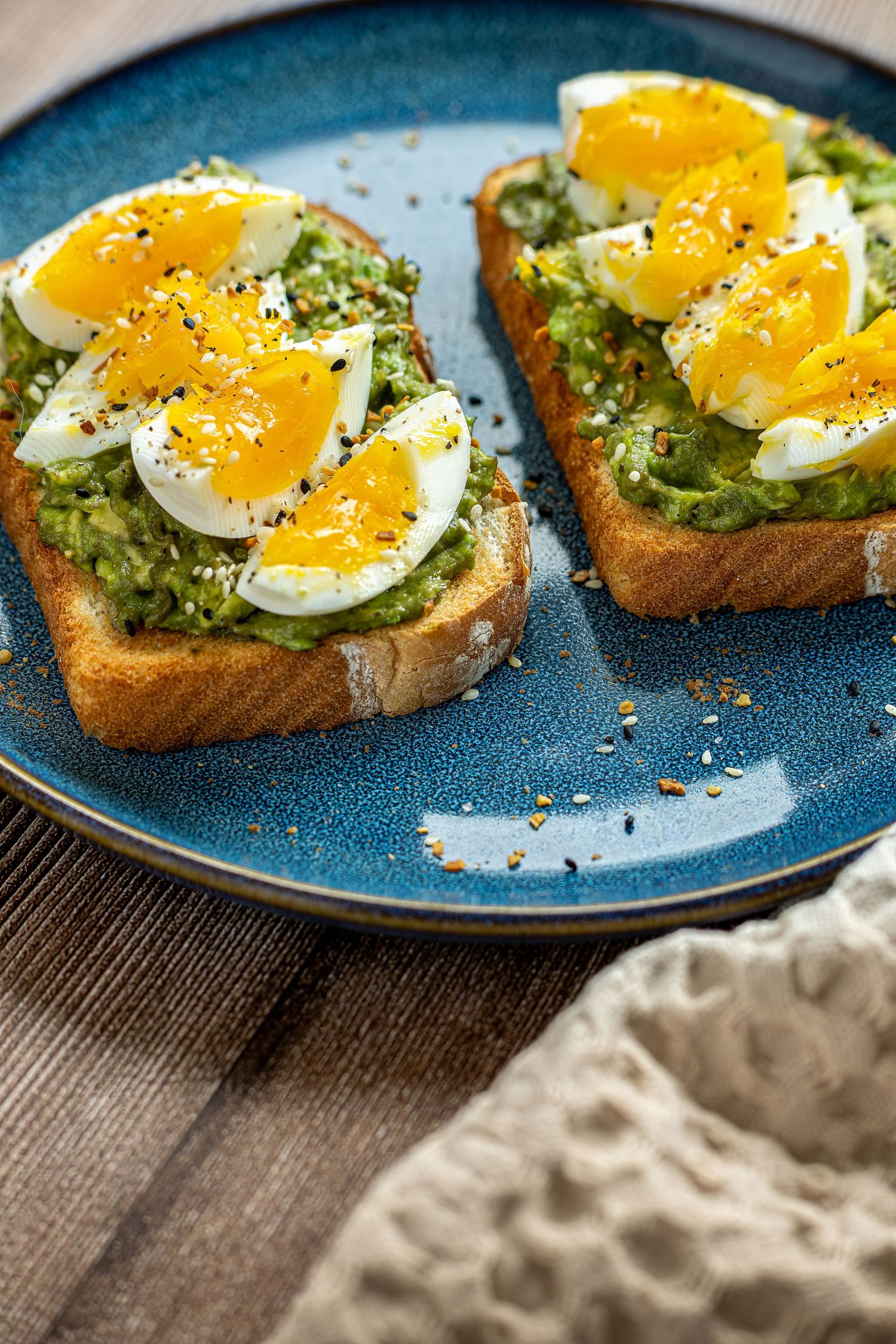 Avocado toast with soft-boiled eggs, captured in modern brunch photography for creative visual content.