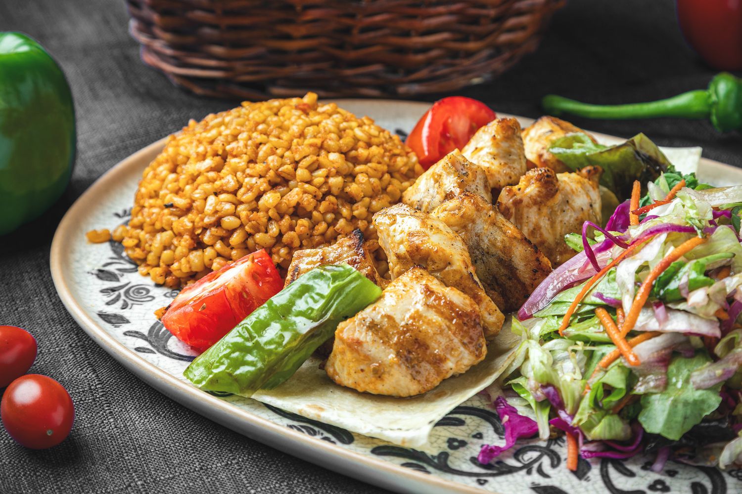 Grilled chicken breasts served with fresh salad and lentils on white plates against a dark background.