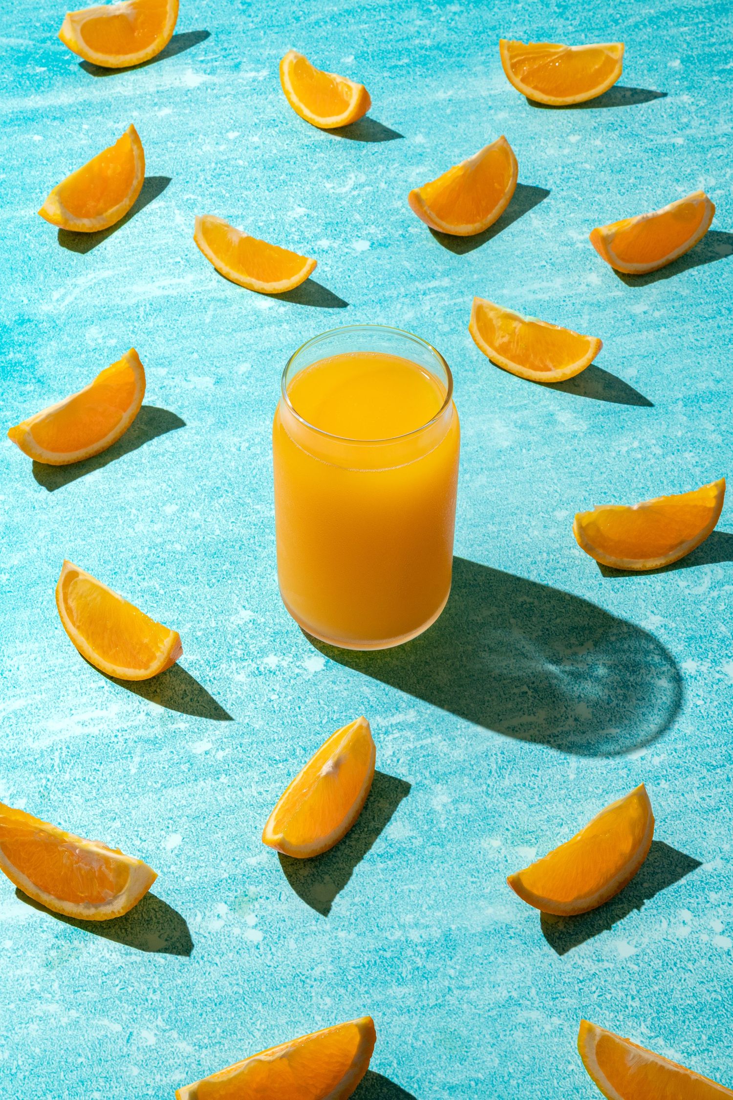 Creative food content with a glass of orange juice surrounded by citrus slices, intended for use in creative photography and video.