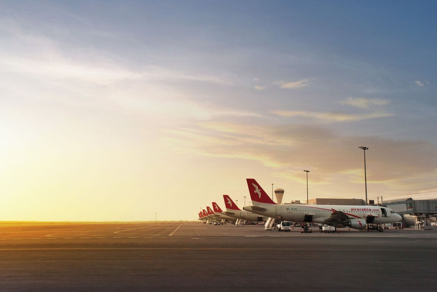 Fleet photography of multiple planes parked under a dramatic sunset sky, produced for use in creative visual content.