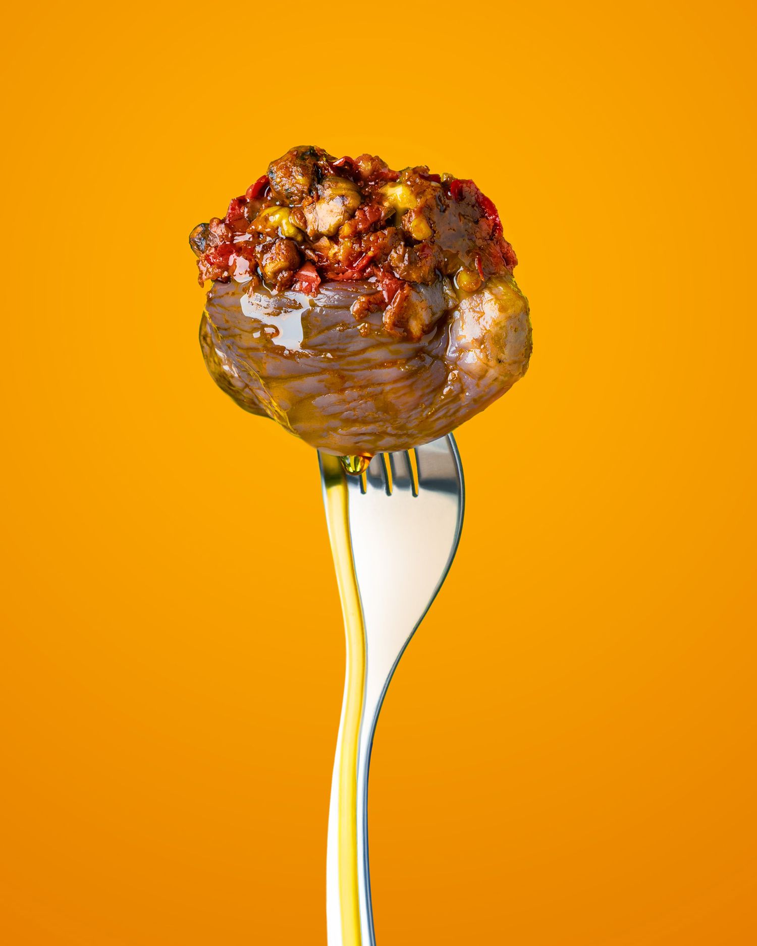 A chocolate-covered strawberry decorated with drizzles of milk chocolate and colorful sprinkles on an orange background.