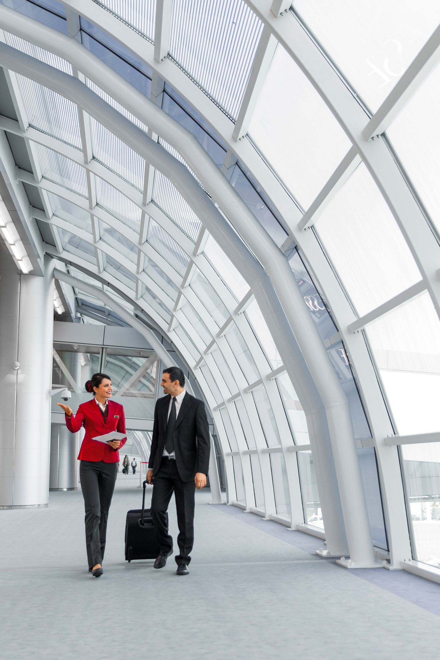 Traveler and an agent walk through a modern, curved airport terminal, created for use in marketing and social media content.