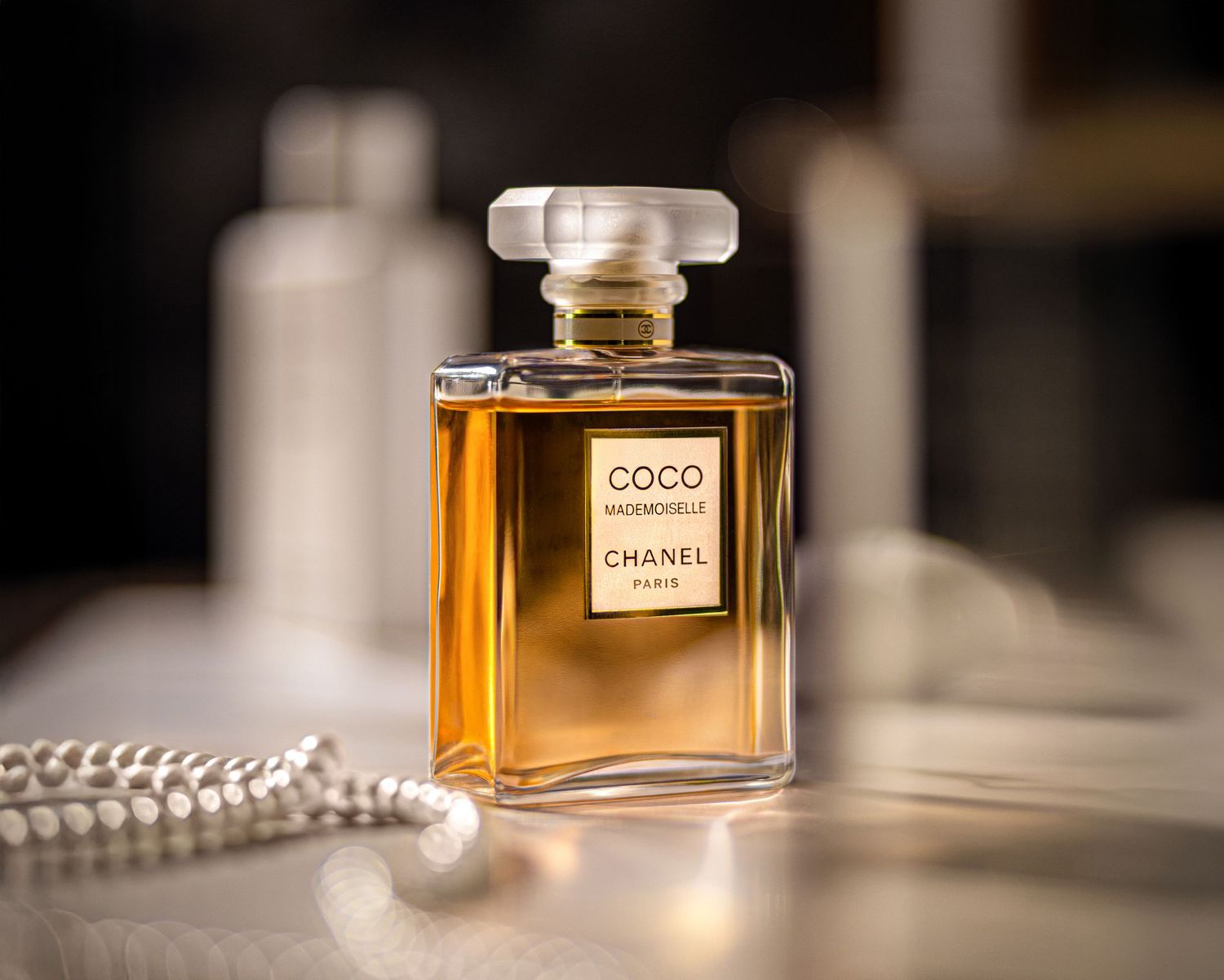 High-end product photography of a COCO Chanel perfume bottle styled for commercial content.