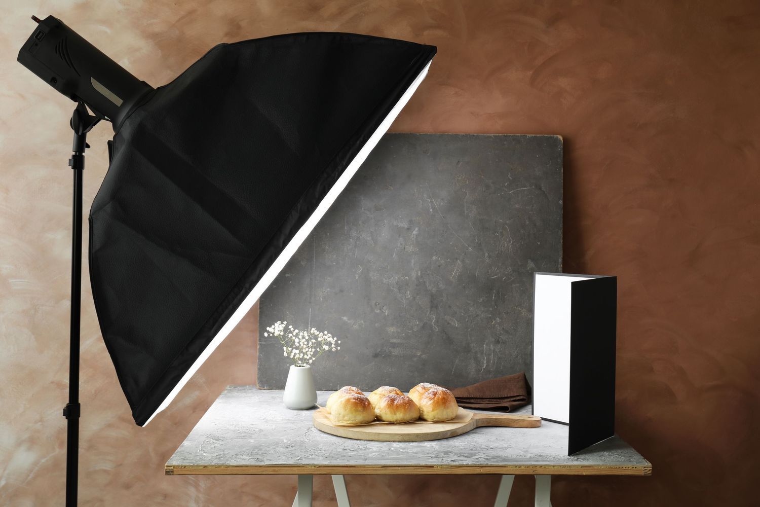 Studio setup for food photography with lighting equipment and a styling station for creative visual content.