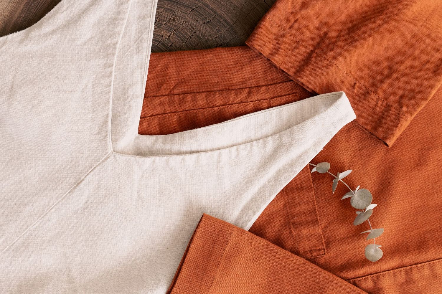 Orange and white fabric swatches laid out in a row showing folded details and stitching patterns.