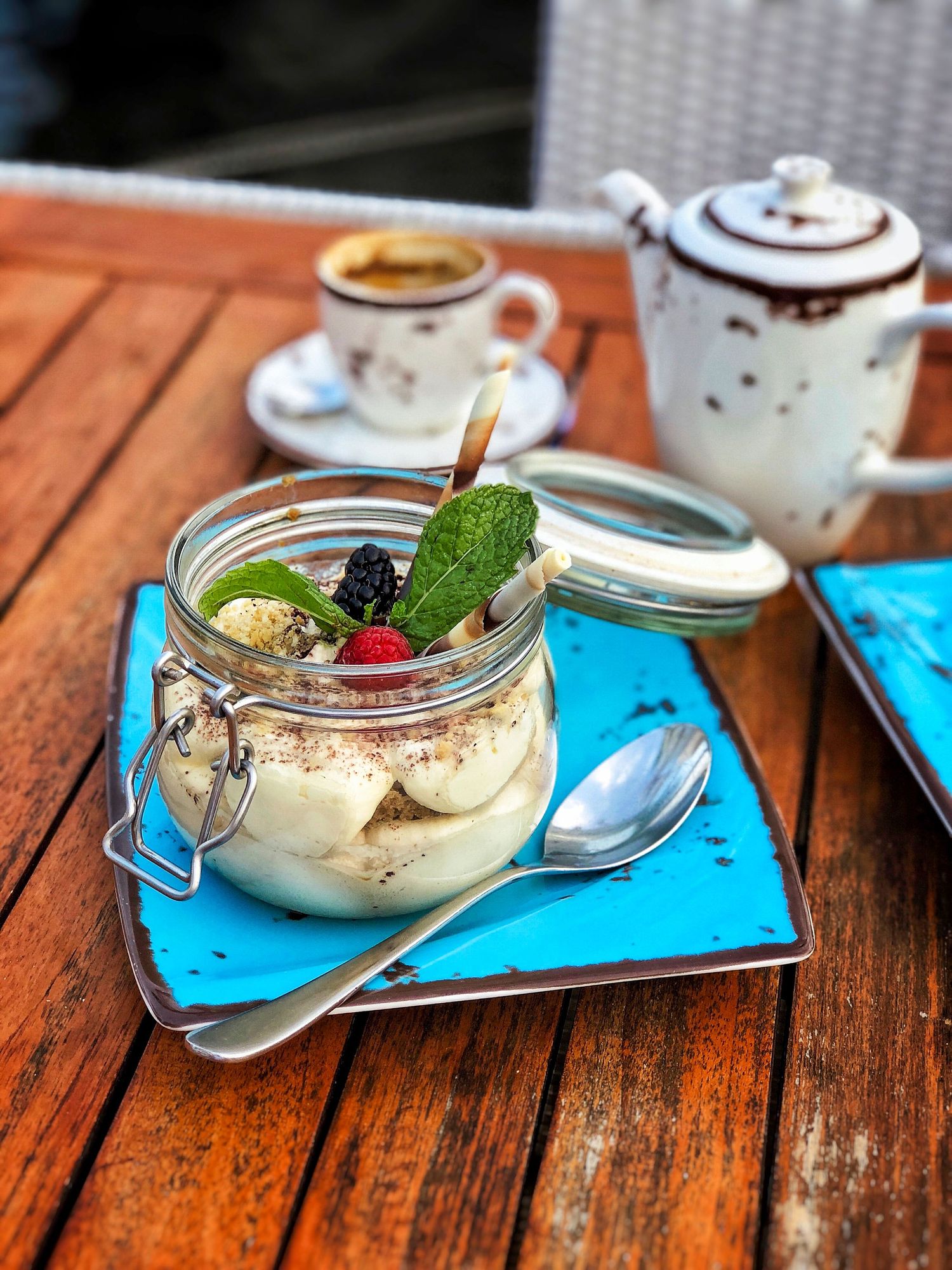 Artisan tiramisu dessert with espresso served on a rustic wooden table, styled for food photography and video content