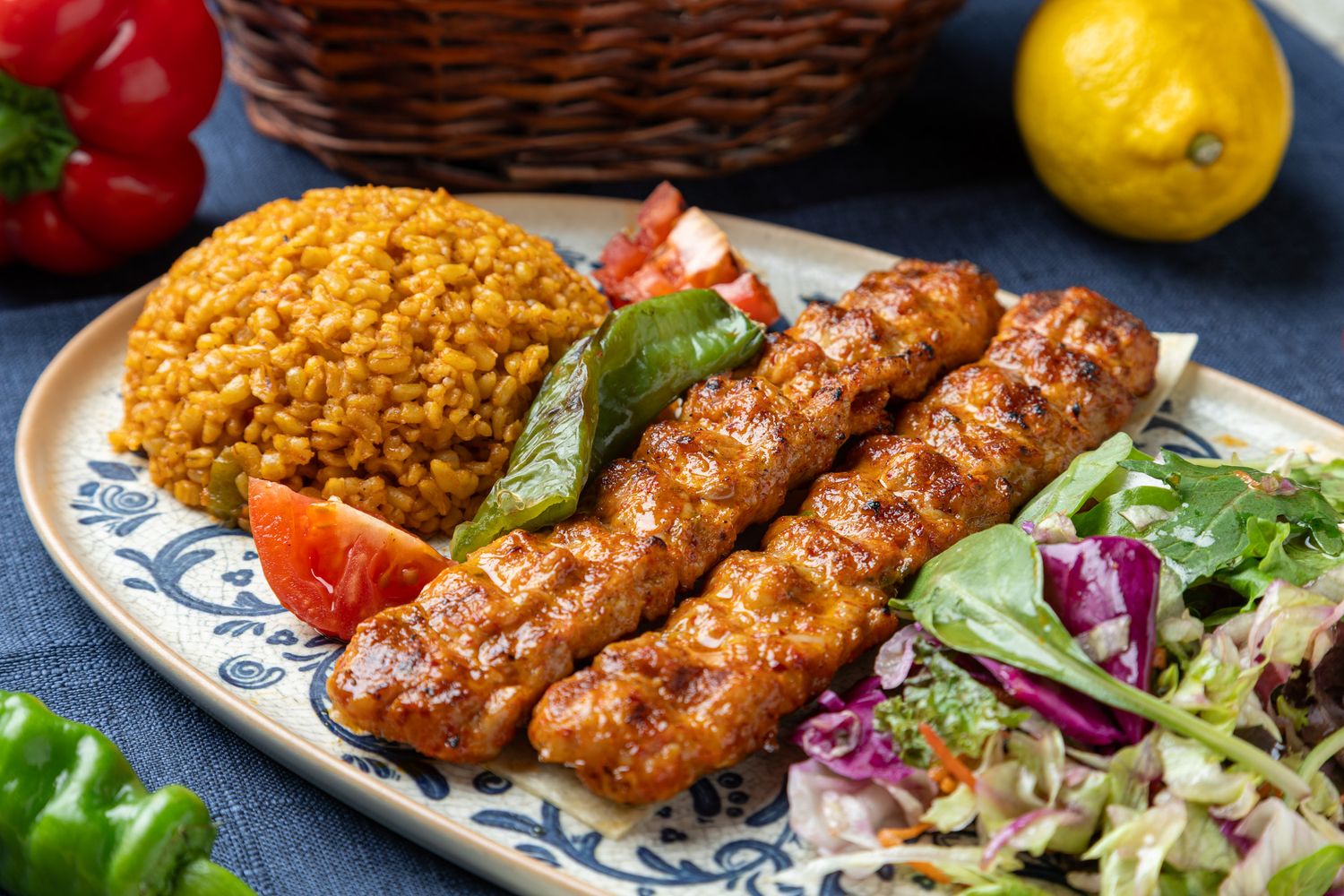 Menu photography of a grilled kebabs served with rice and fresh vegetables