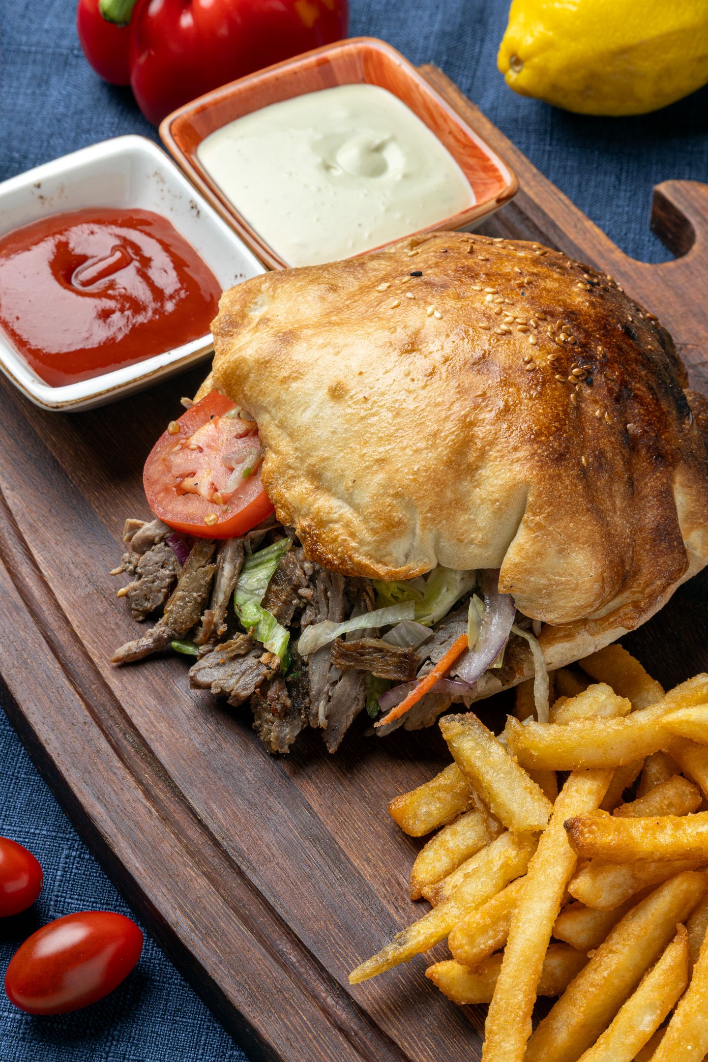 Food photography of a Juicy beef sandwich served on rustic wooden board with crispy french fries