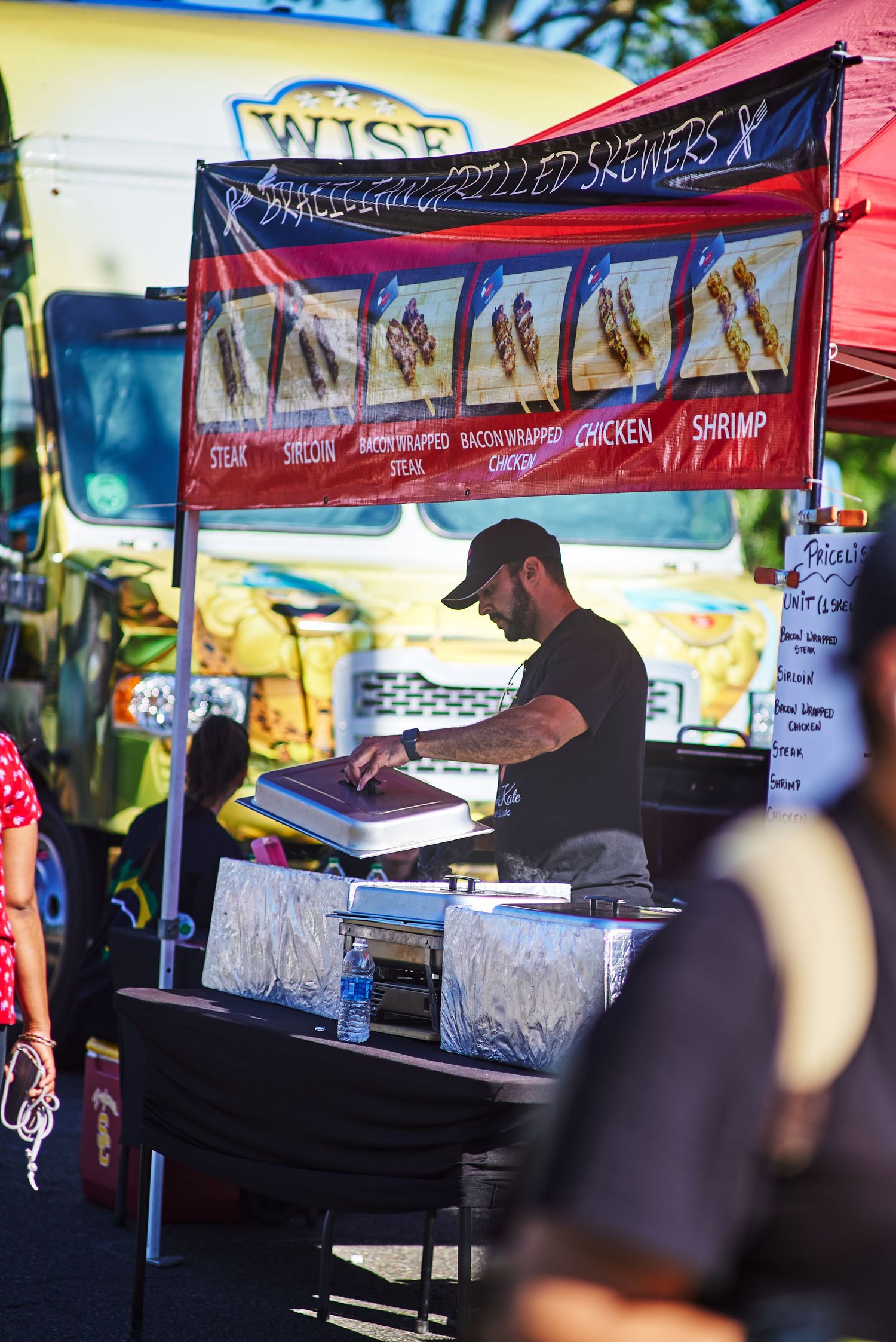 Food vendor booth at festival displaying menu of deep fried snacks.