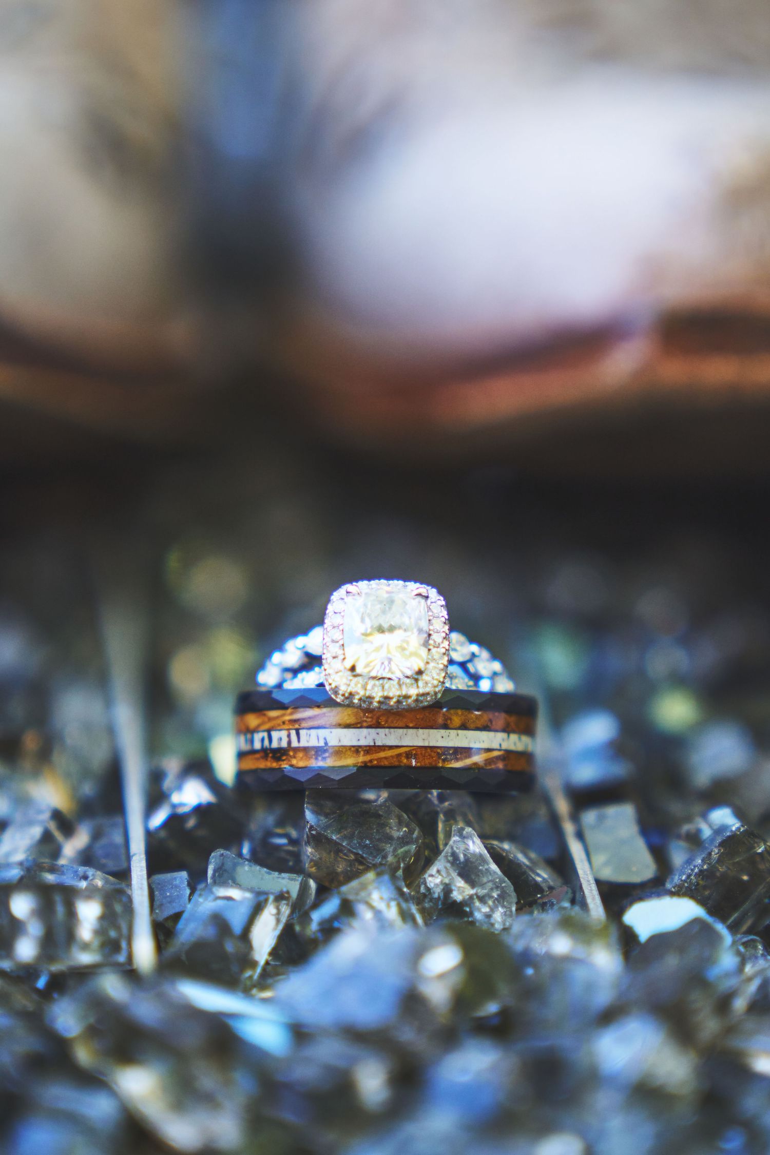 Wedding rings displayed on sparkling crystal surface with macro detail.