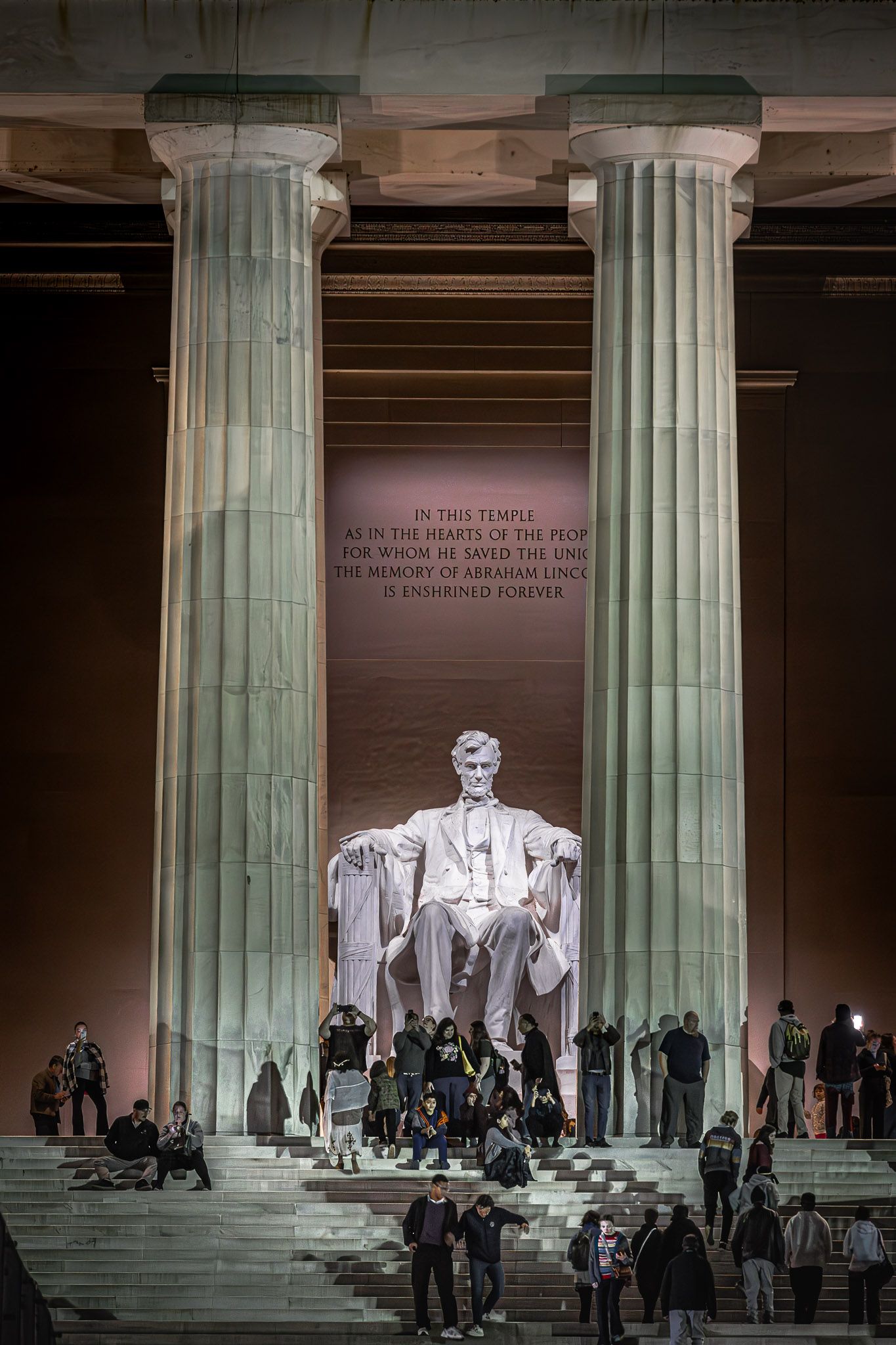 Visitors at the Lincoln Memorial beneath the seated Abraham Lincoln statue