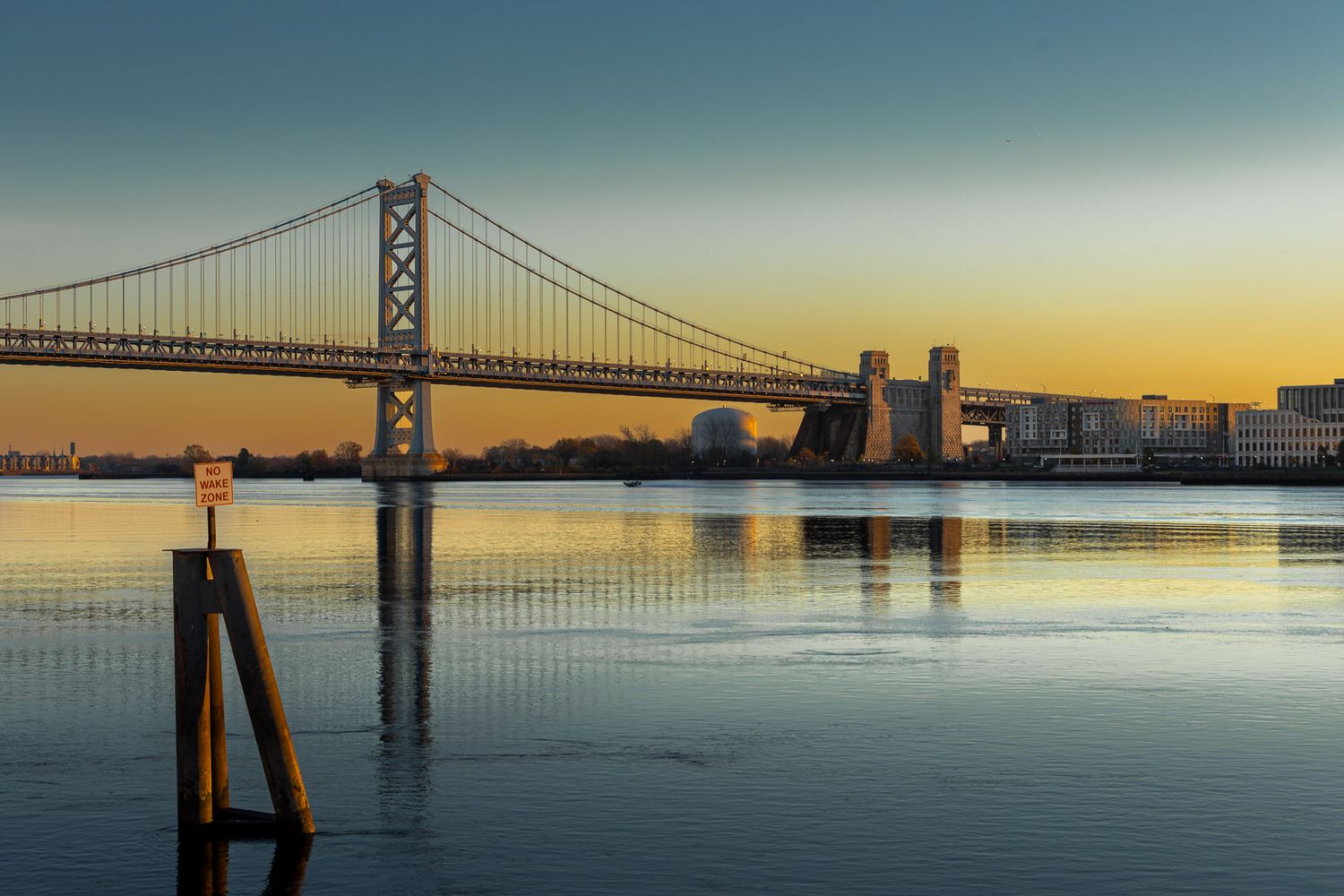 Dawn landscape of the Ben Franklin Bridge spanning Philadelphia and Camden over still water