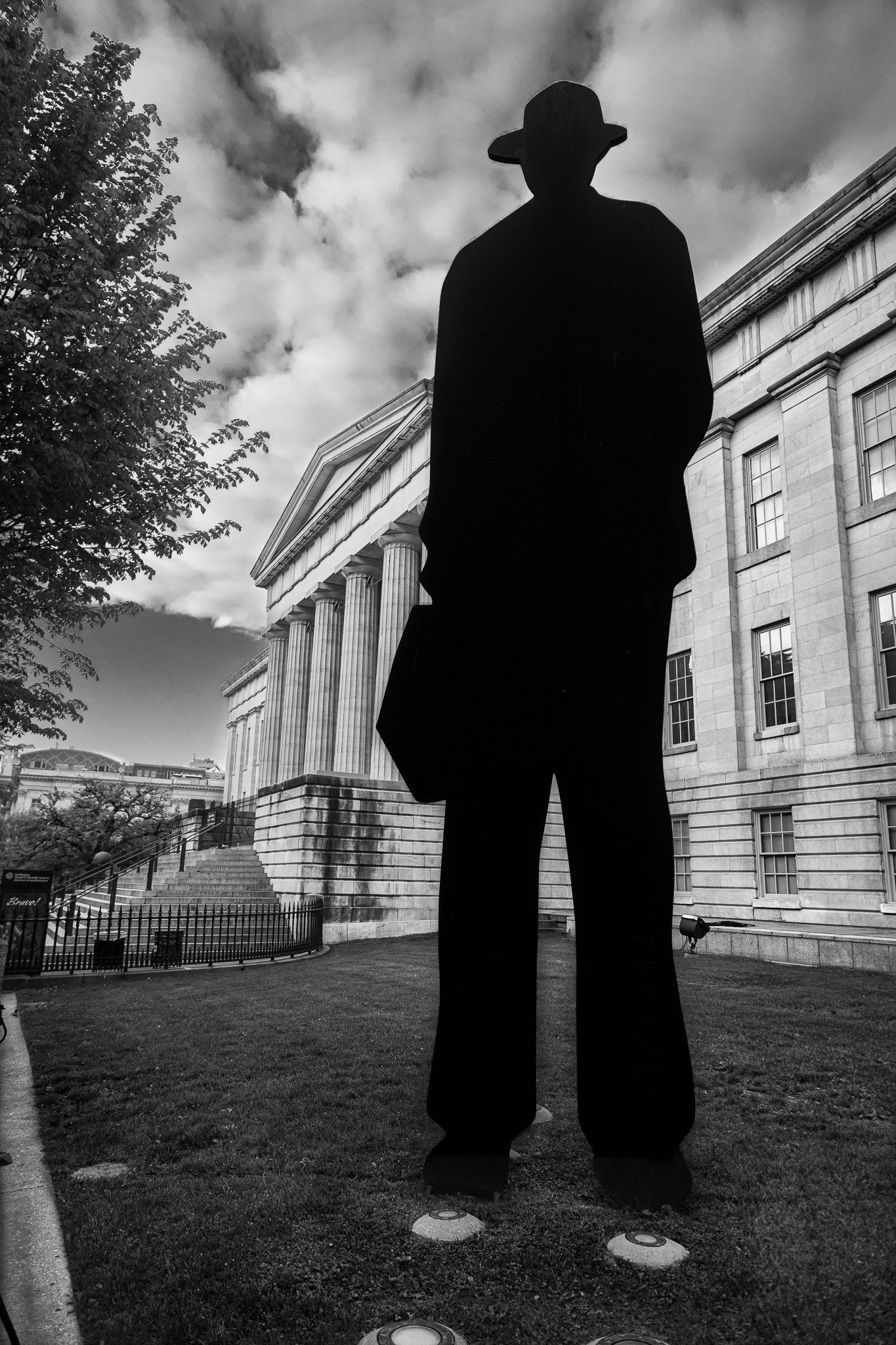 “Man with Briefcase” statue outside the National Portrait Gallery in Washington, DC, photographed in black and white.
