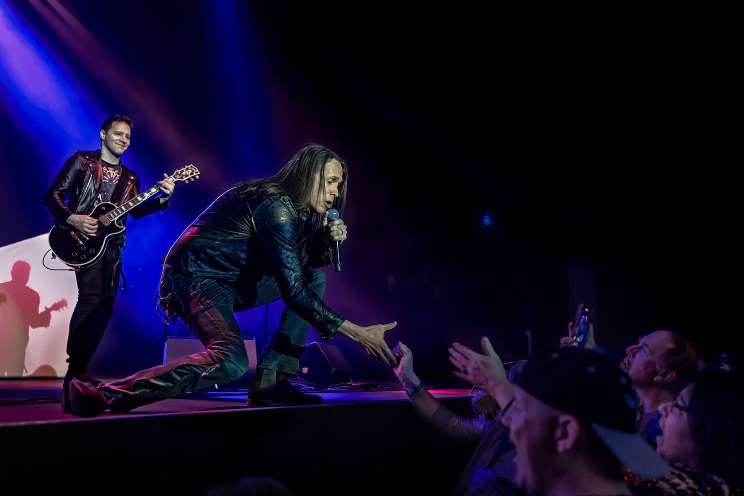 Lead singer of Voyage interacting with fans during a live performance at Wind Creek Event Center in Bethlehem, PA.