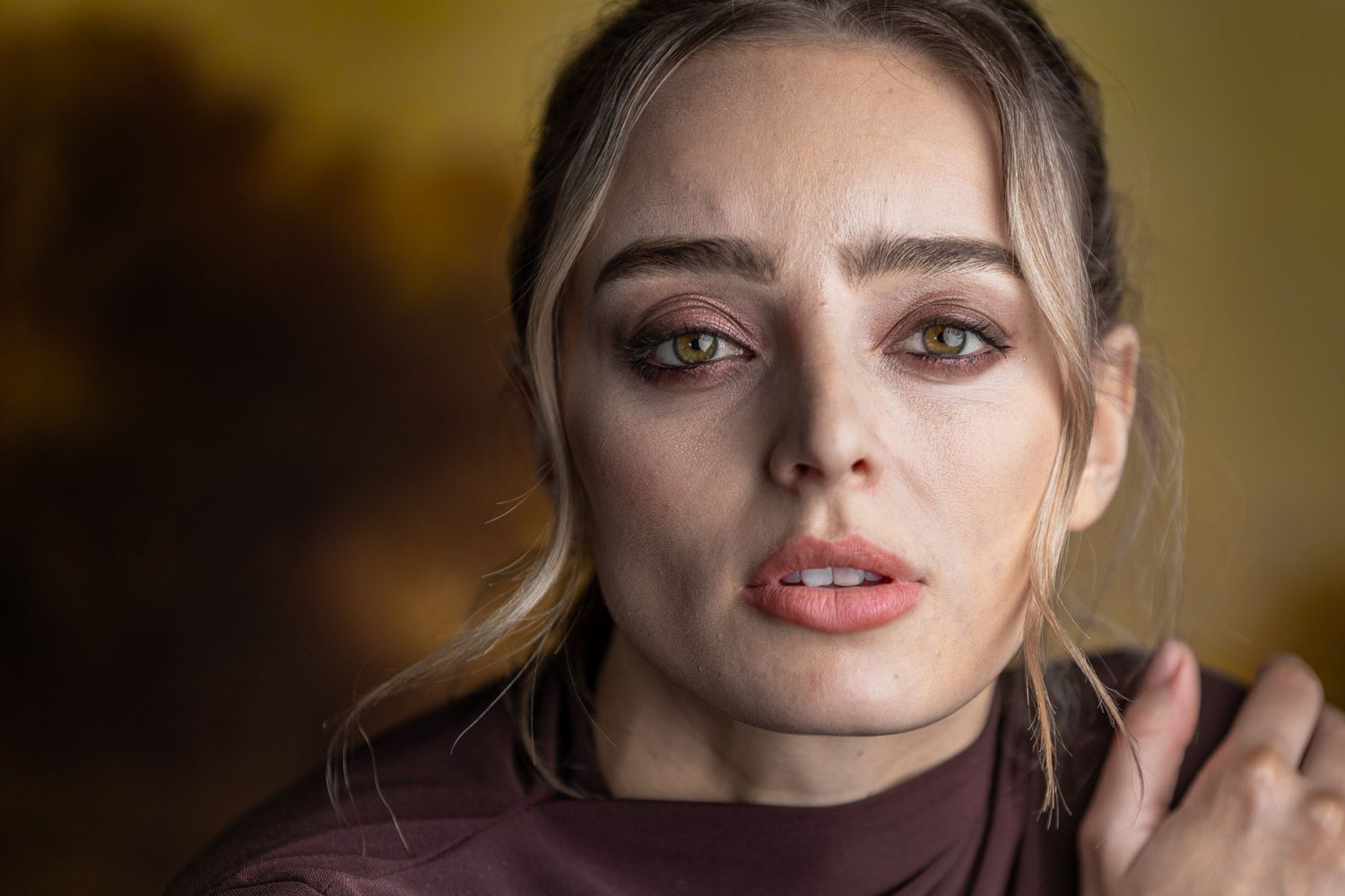 Close-up portrait of woman with green eyes and soft dramatic lighting, fine art studio photography