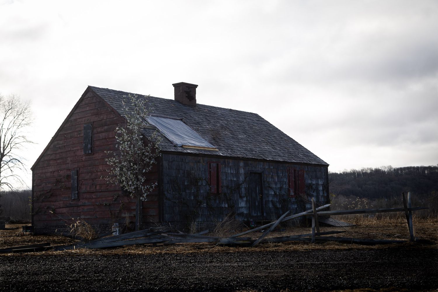 Weathered farmhouse film set in rural Great Meadows New Jersey under overcast sky