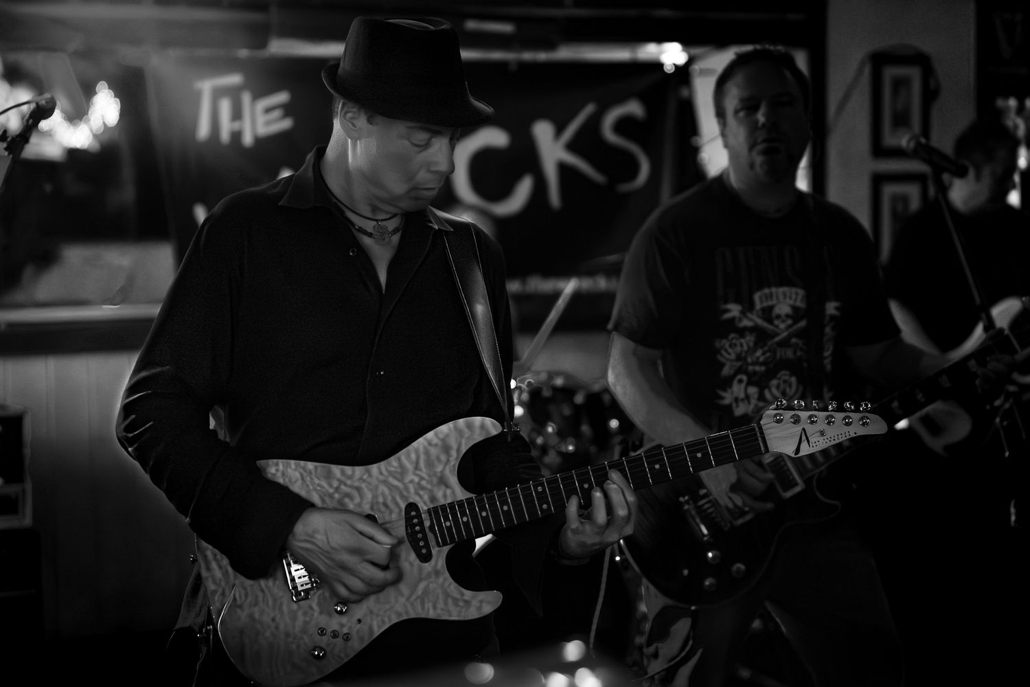 Black and white photo of a guitarist performing live with The Wrecks