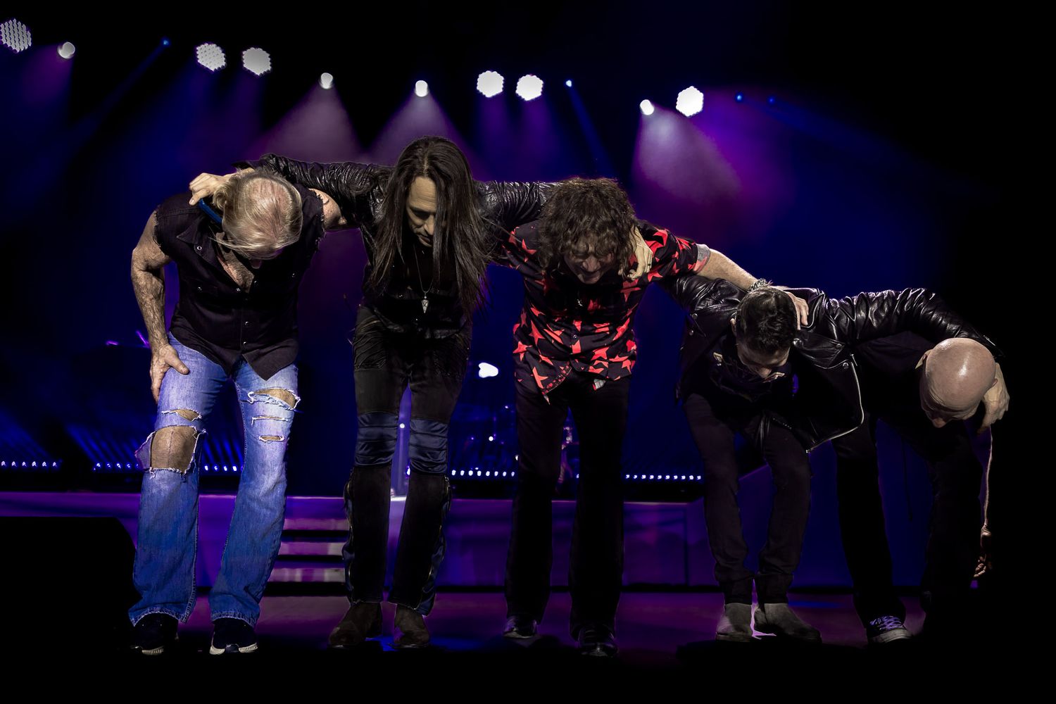 Voyage taking a collective bow at the conclusion of a live performance at Wind Creek Event Center in Bethlehem, PA.