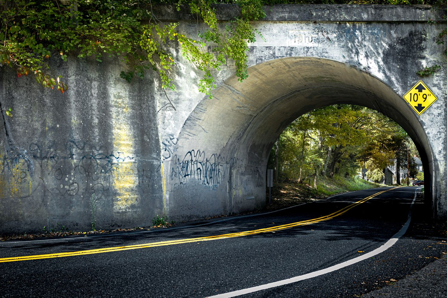 Historic road tunnel in Blairstown, New Jersey framed by trees and autumn light.