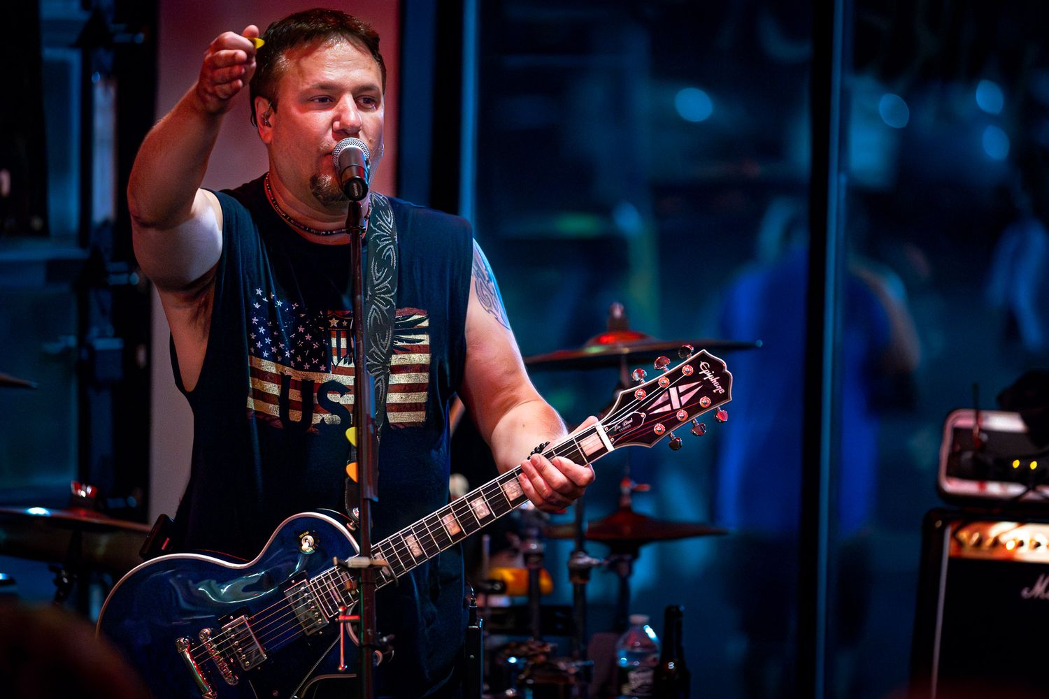 Guitarist performing live with The Wrecks, a New Jersey cover band, at a small venue with dramatic stage lighting