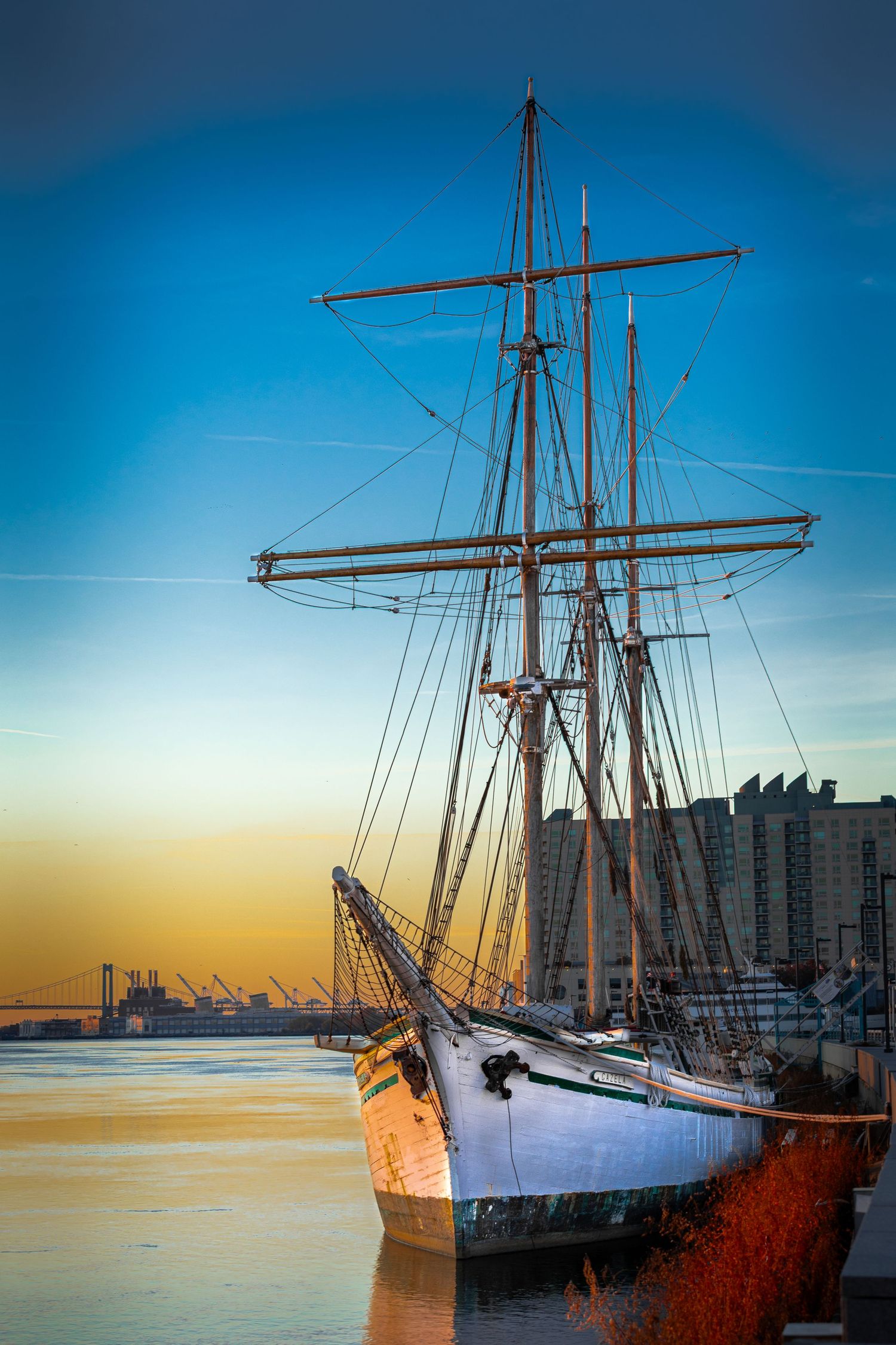 Tall ship at dawn on the Delaware River with the Walt Whitman Bridge in the background