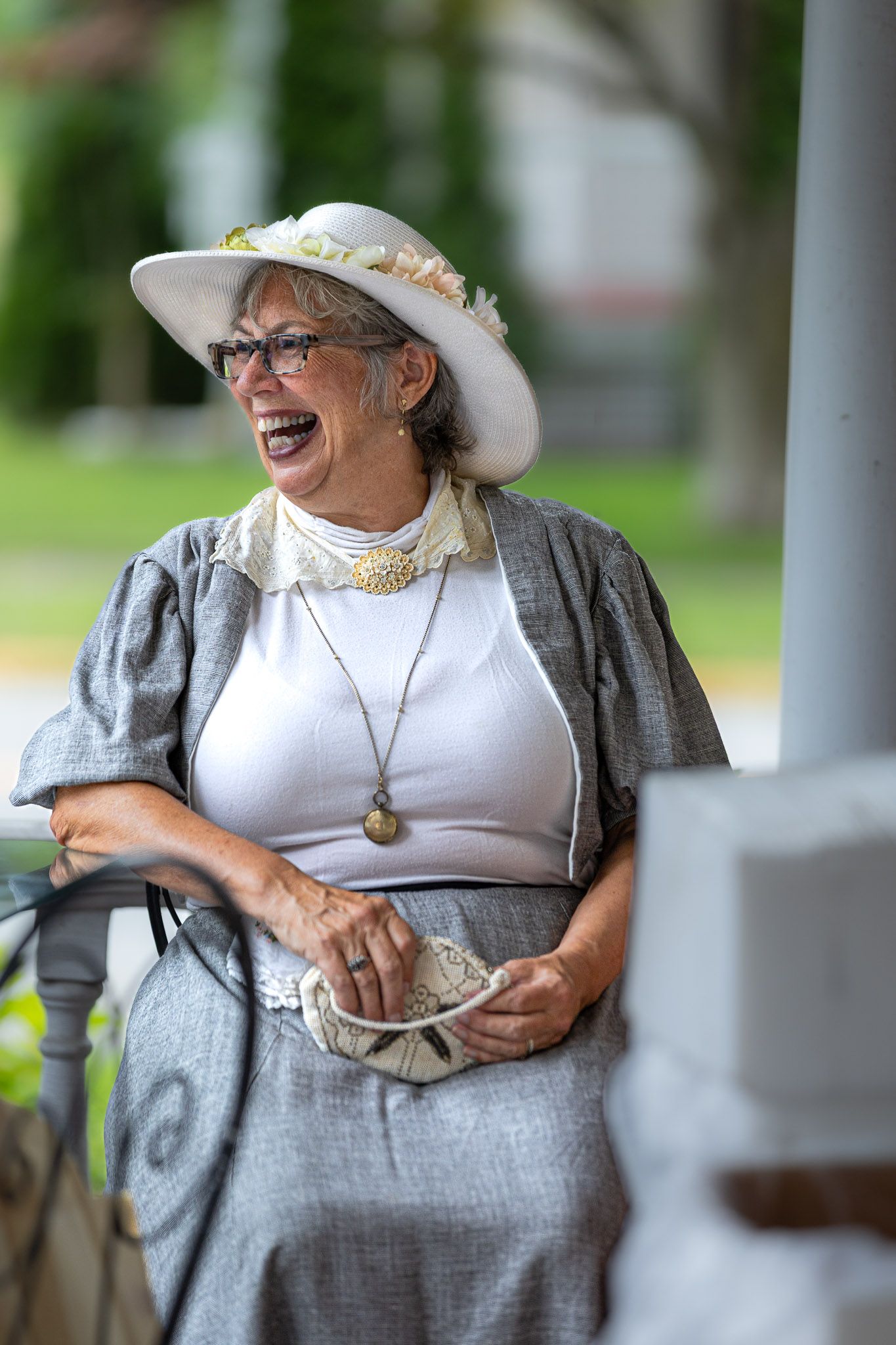 Woman in Victorian-era clothing laughing at Victorian Day event in Belvidere, New Jersey