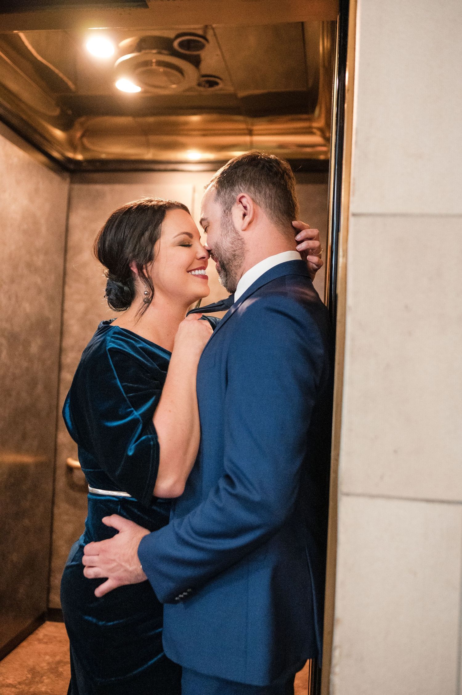 Romantic couple sharing intimate moment in elegant formal attire.