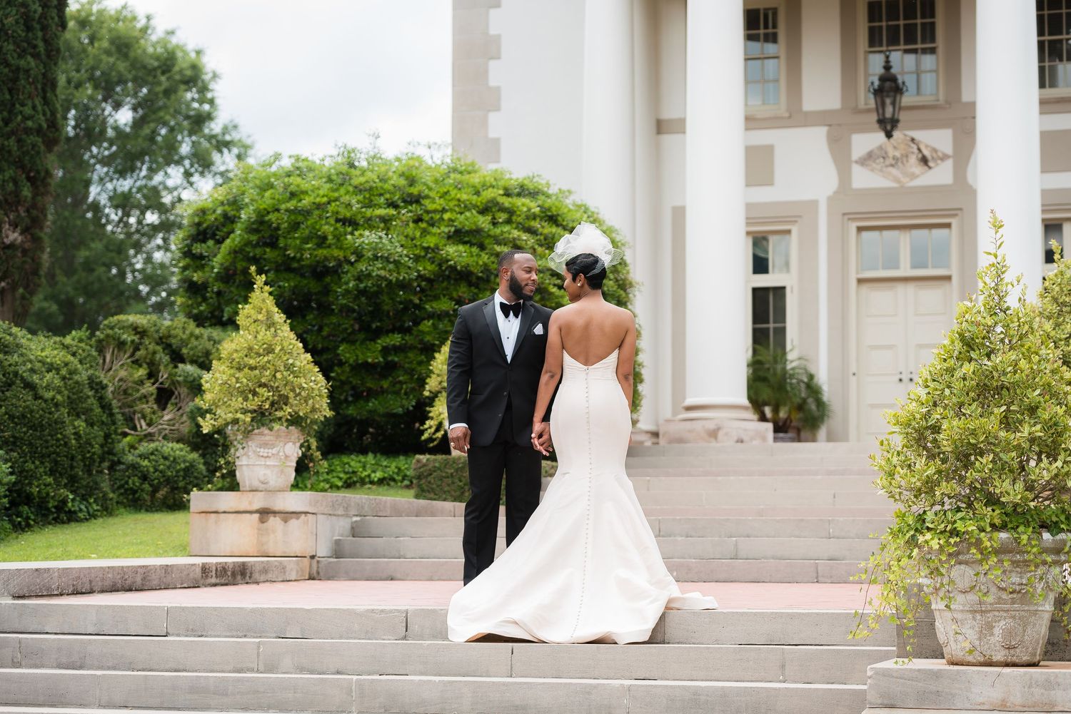 Classic wedding venue exterior featuring white columns and grand architectural details.