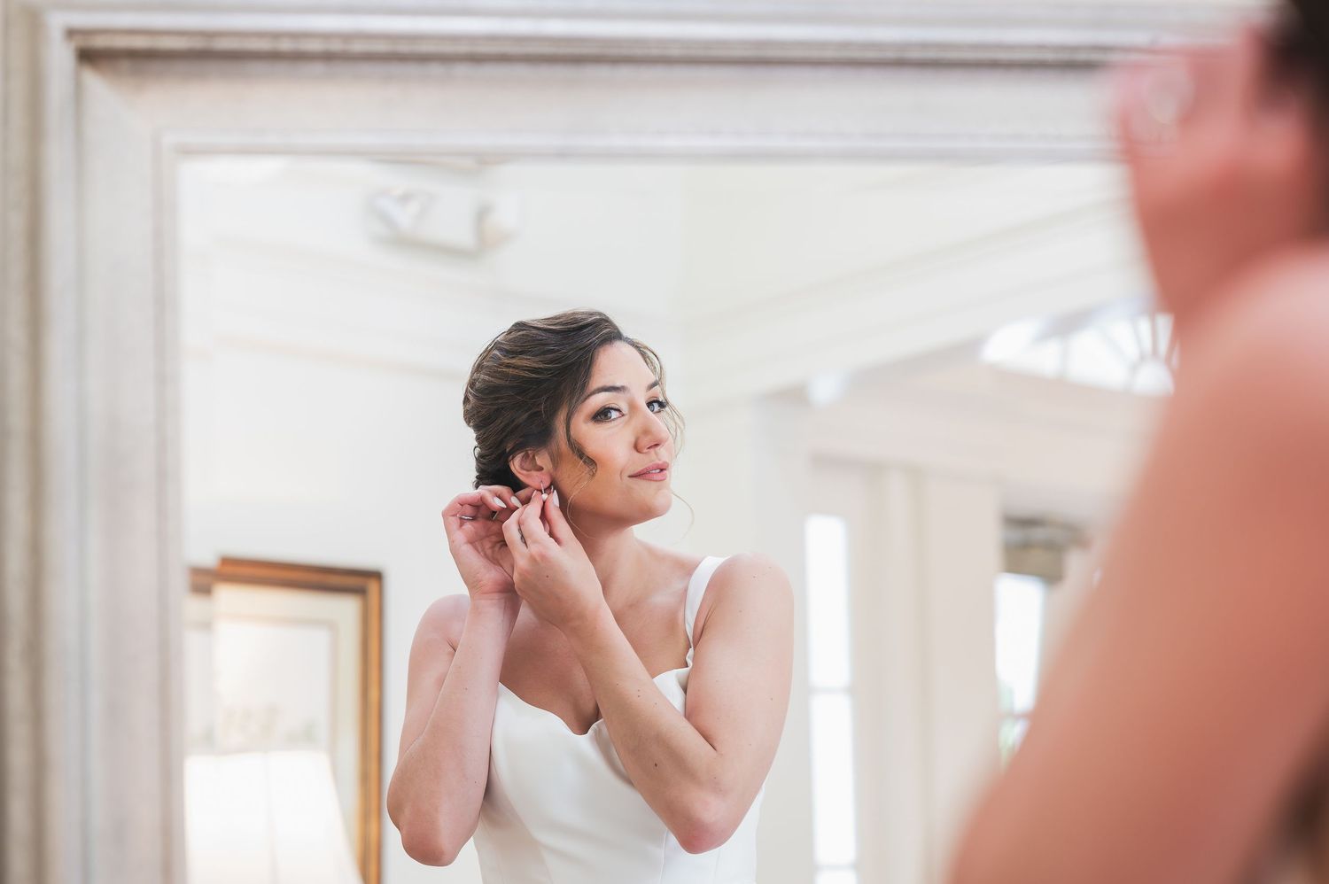 Wedding day preparation and getting ready moments in a bright white room.