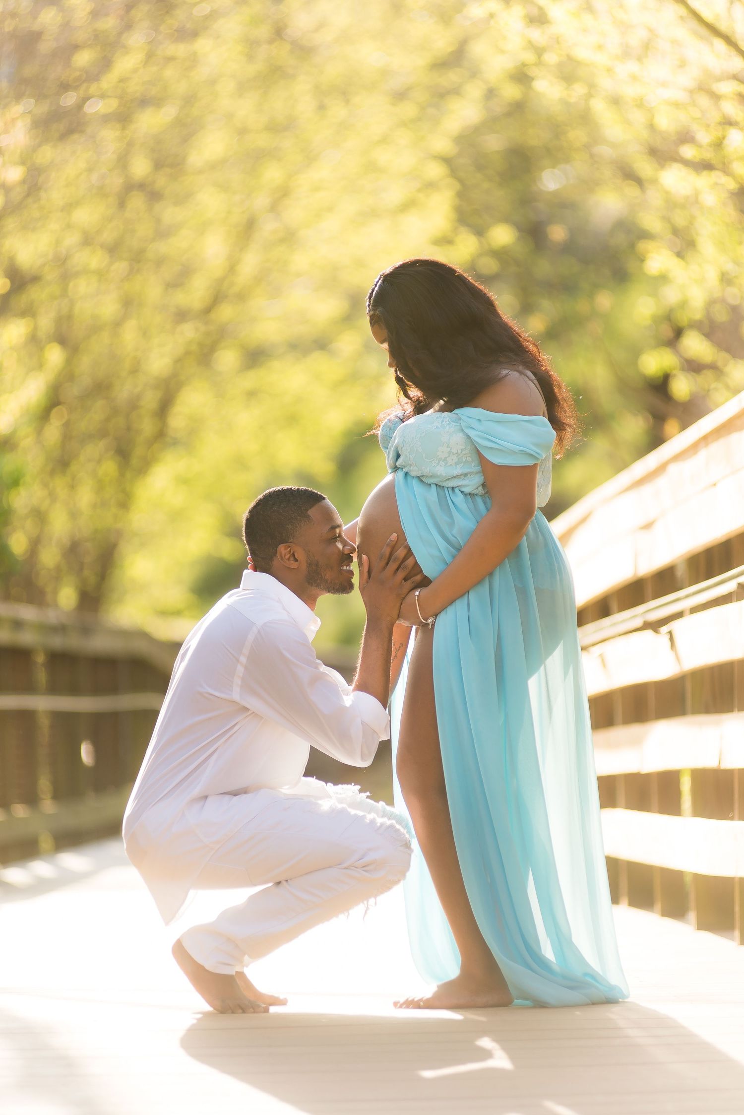 Creative engagement photos on wooden boardwalk with dramatic sunset lighting.