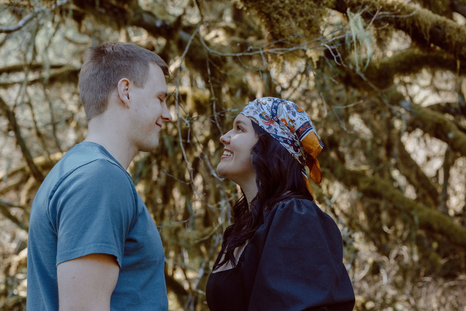 Romantic couple sharing tender moments in a woodsy setting across five sequential photos.