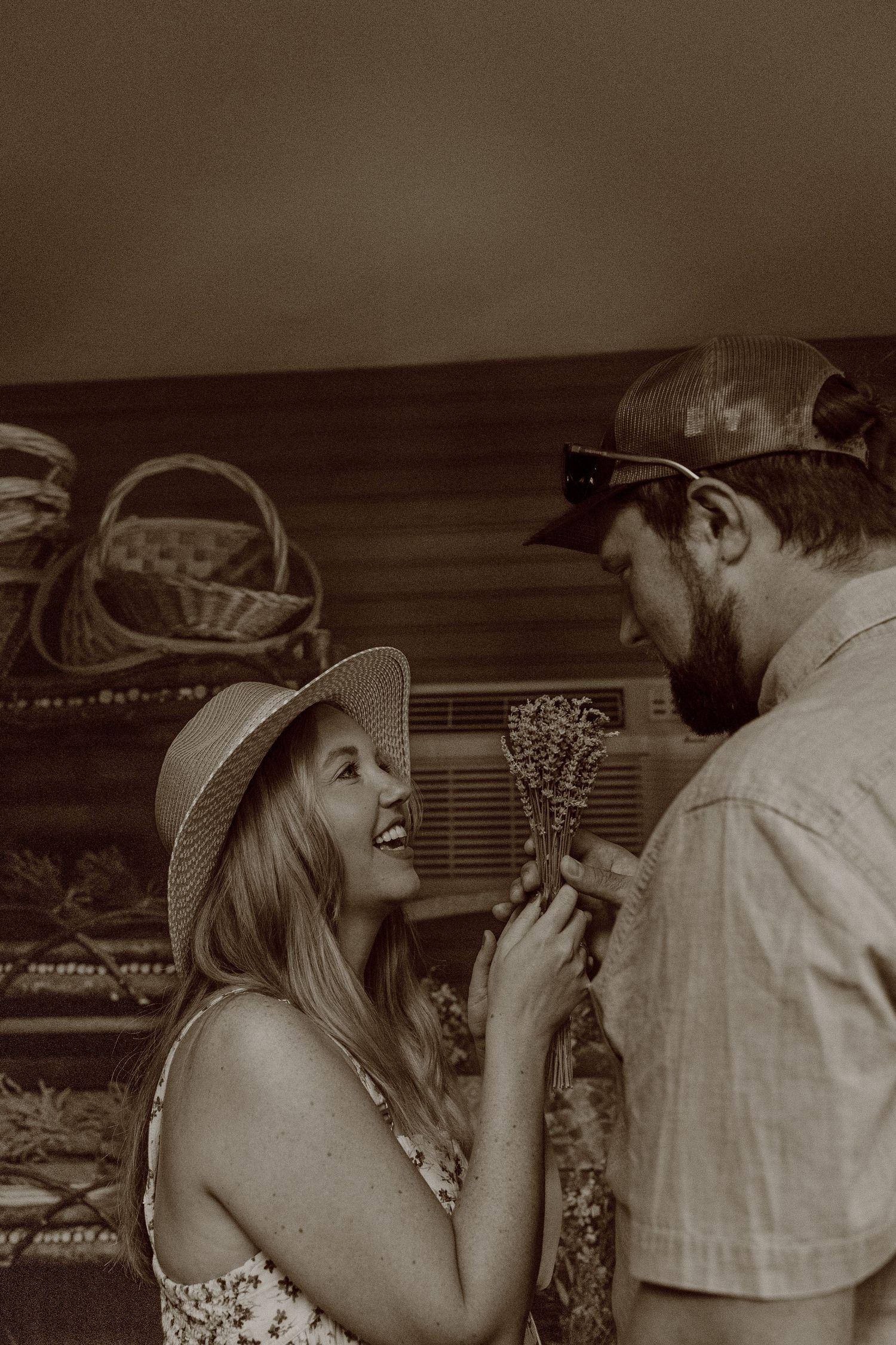 Two people smile and laugh while facing each other in black and white vintage photographs.
