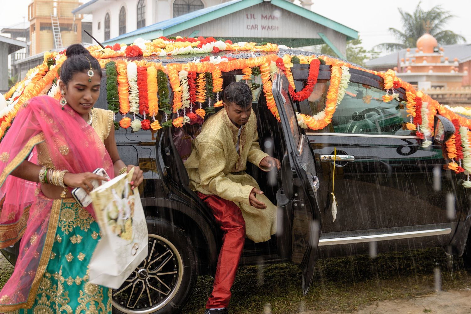 Outdoor wedding celebration with guests in traditional African attire and decorative elements.