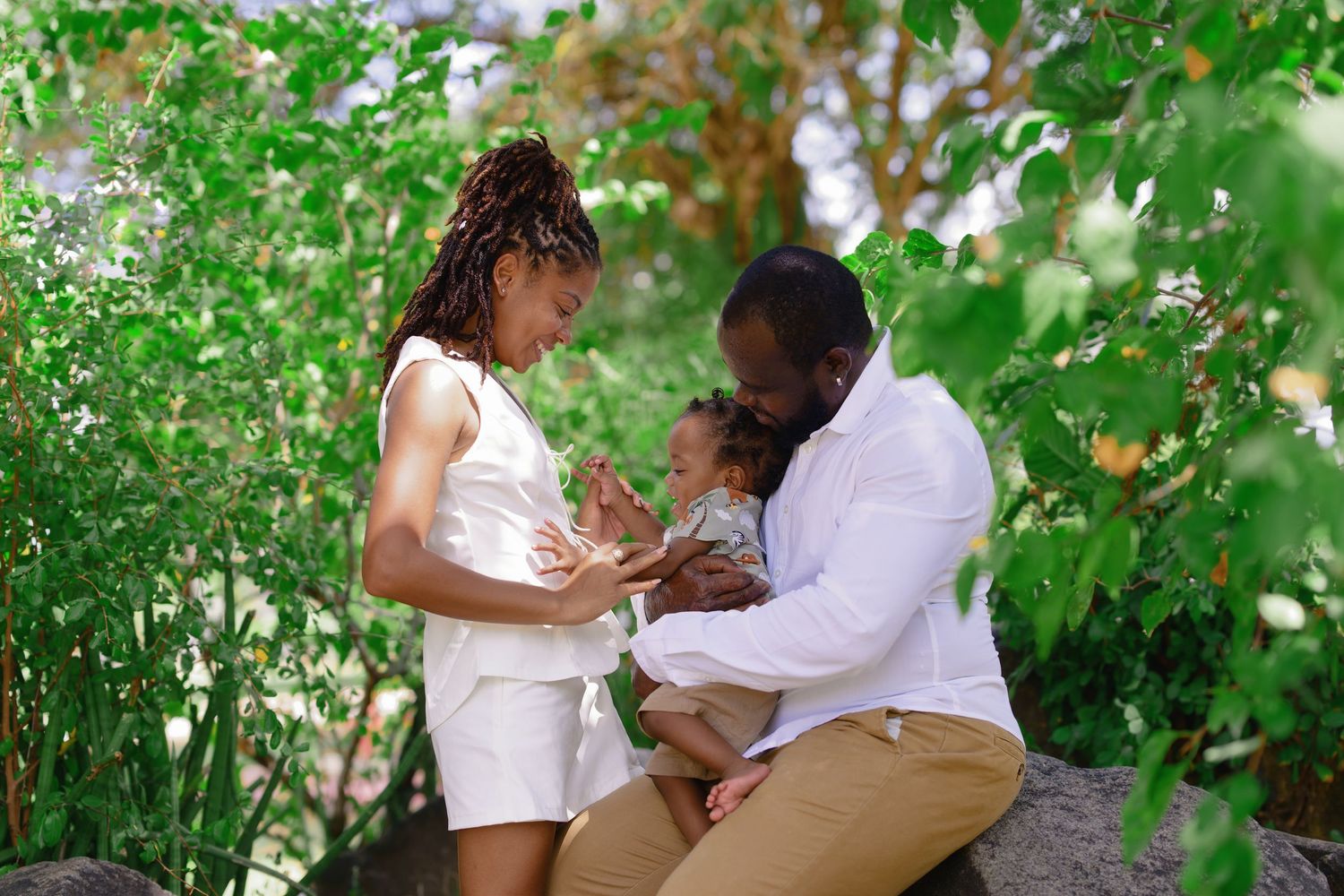 Couple sharing intimate moment in lush garden setting.