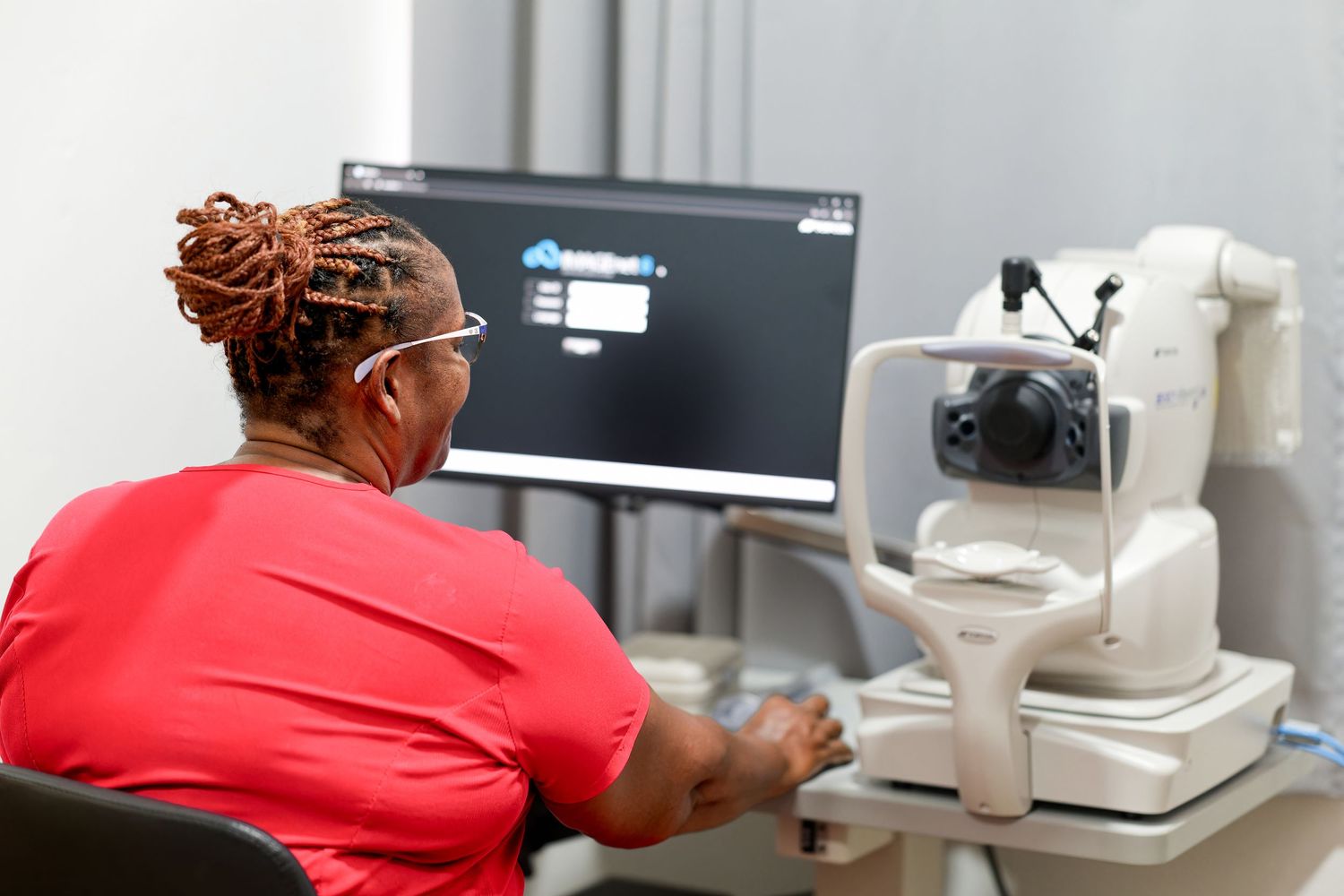 Medical professionals working with advanced diagnostic equipment in a clinical setting.