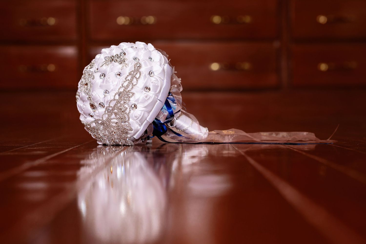 A sparkling diamond engagement ring sits elegantly against a rich wooden surface.