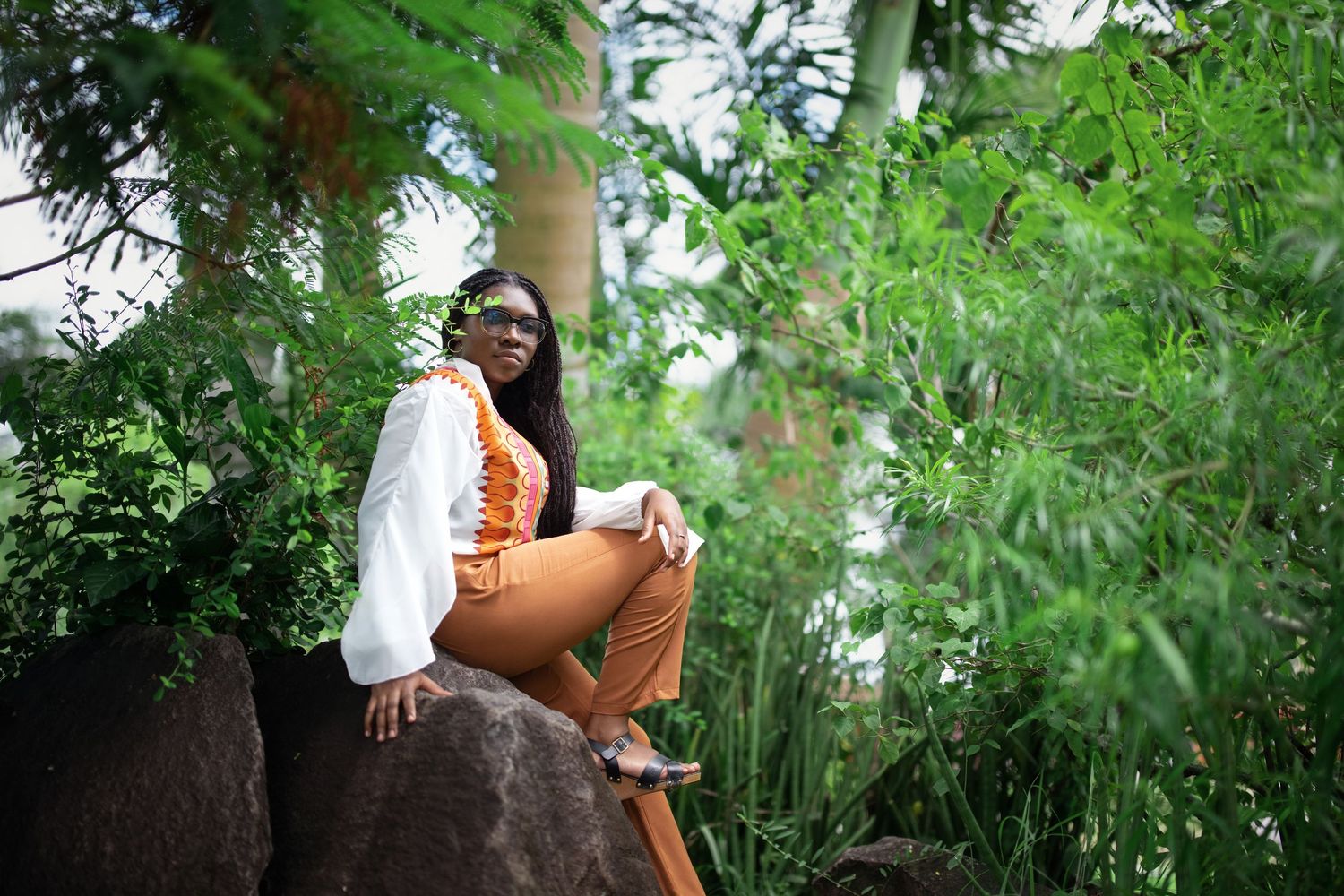 Portrait session in lush green garden setting with natural lighting.