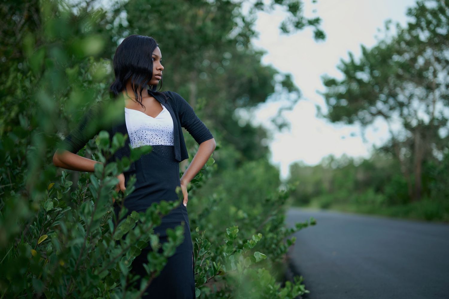 Natural outdoor portrait session with greenery and trees in background.